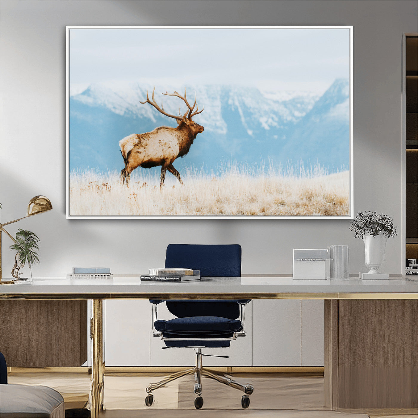 Majestic elk with antlers walking on golden grass, snowy mountains behind, perfect for rustic lodge or Scandinavian decor.