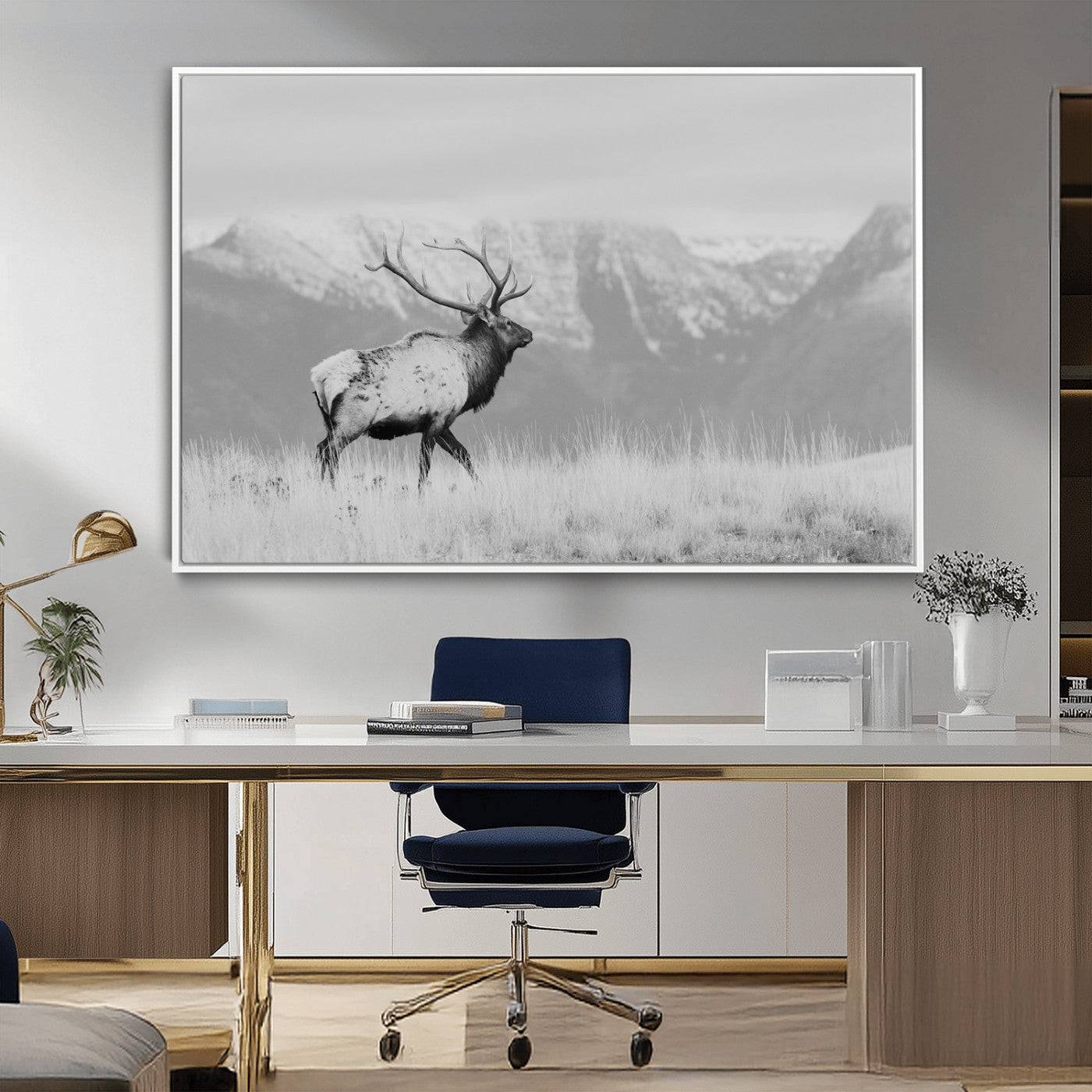 Black and white elk with antlers walking in a field, snowy mountain backdrop, ideal for rustic lodge or minimalist wall decor.