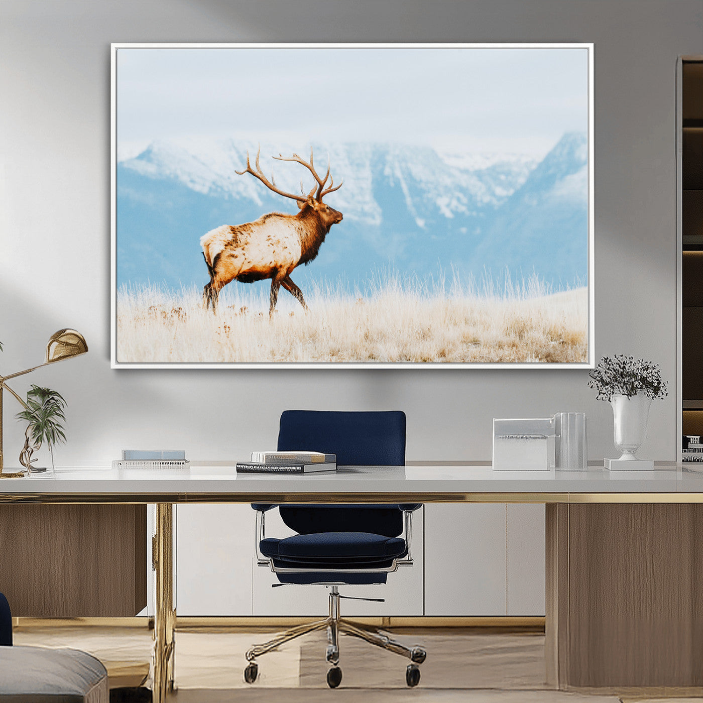 Majestic elk standing on dry grassland with snowy mountains in the background, ideal for rustic or lodge-inspired wall decor.
