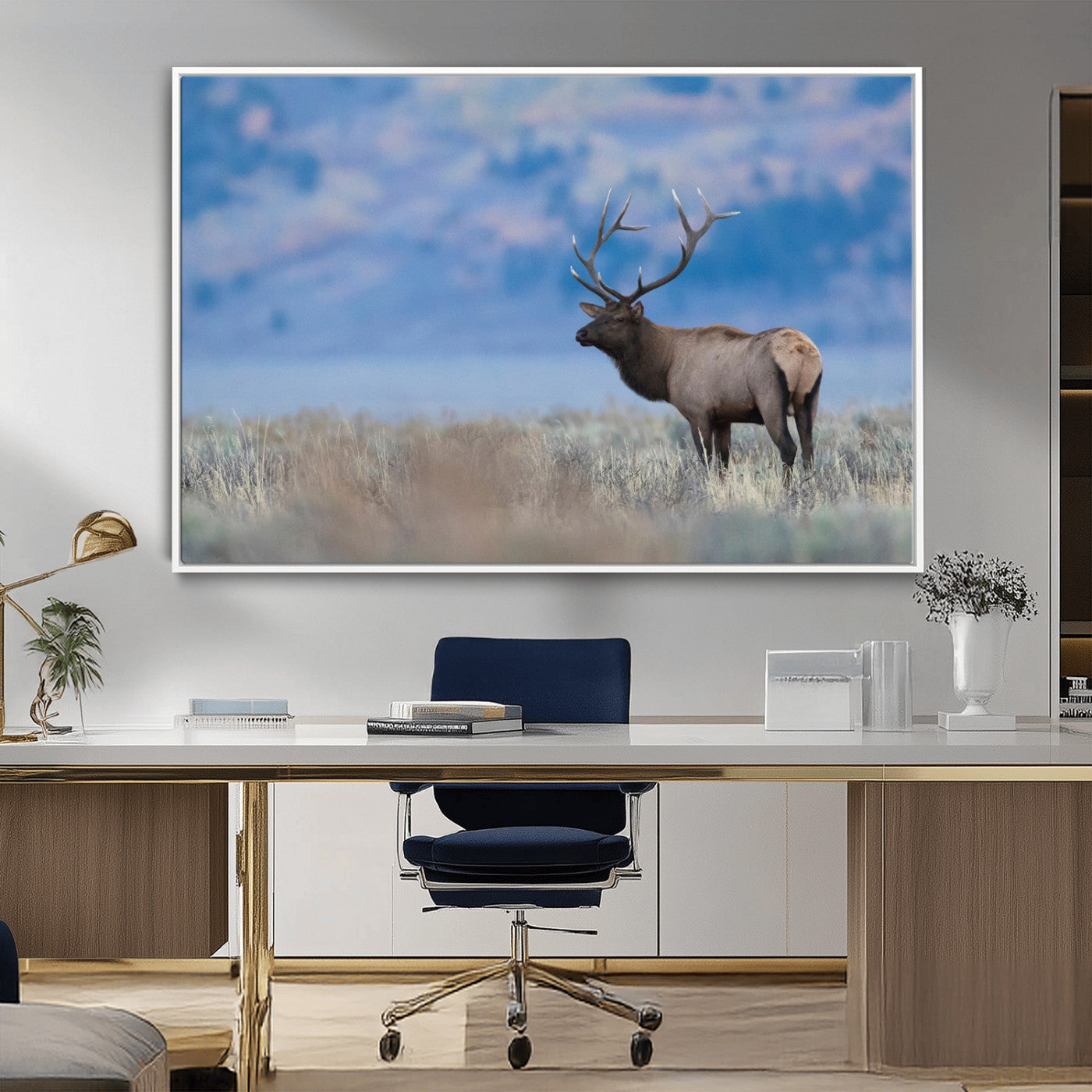 Elk with large antlers standing in open field, mountains blurred in background, perfect for rustic cabin or lodge-style decor.