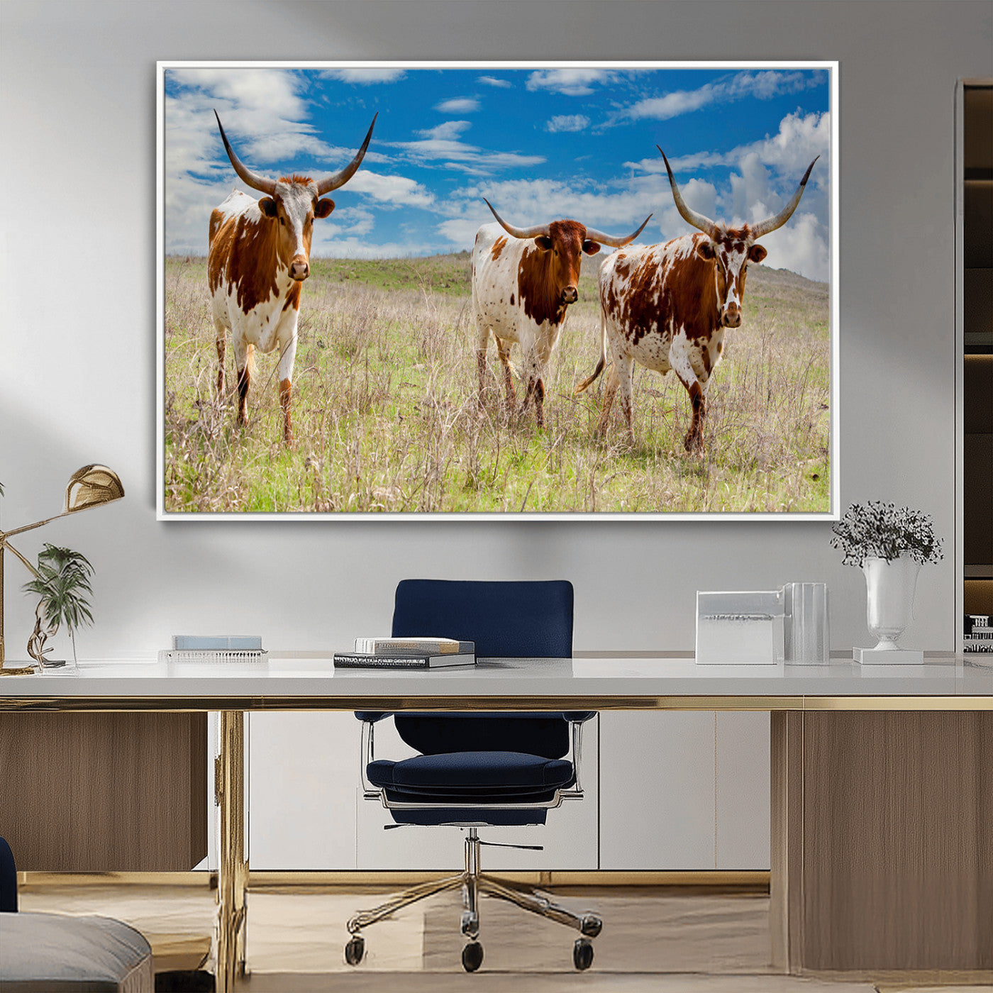 Three Texas longhorn cattle standing in dry grass under a bright blue sky, ideal for farmhouse or western rustic home decor.