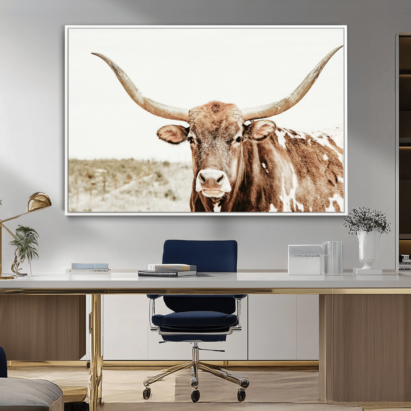 A Texas longhorn bull with wide horns, standing in a dry field under soft light, ideal for rustic farmhouse or western-themed interiors.