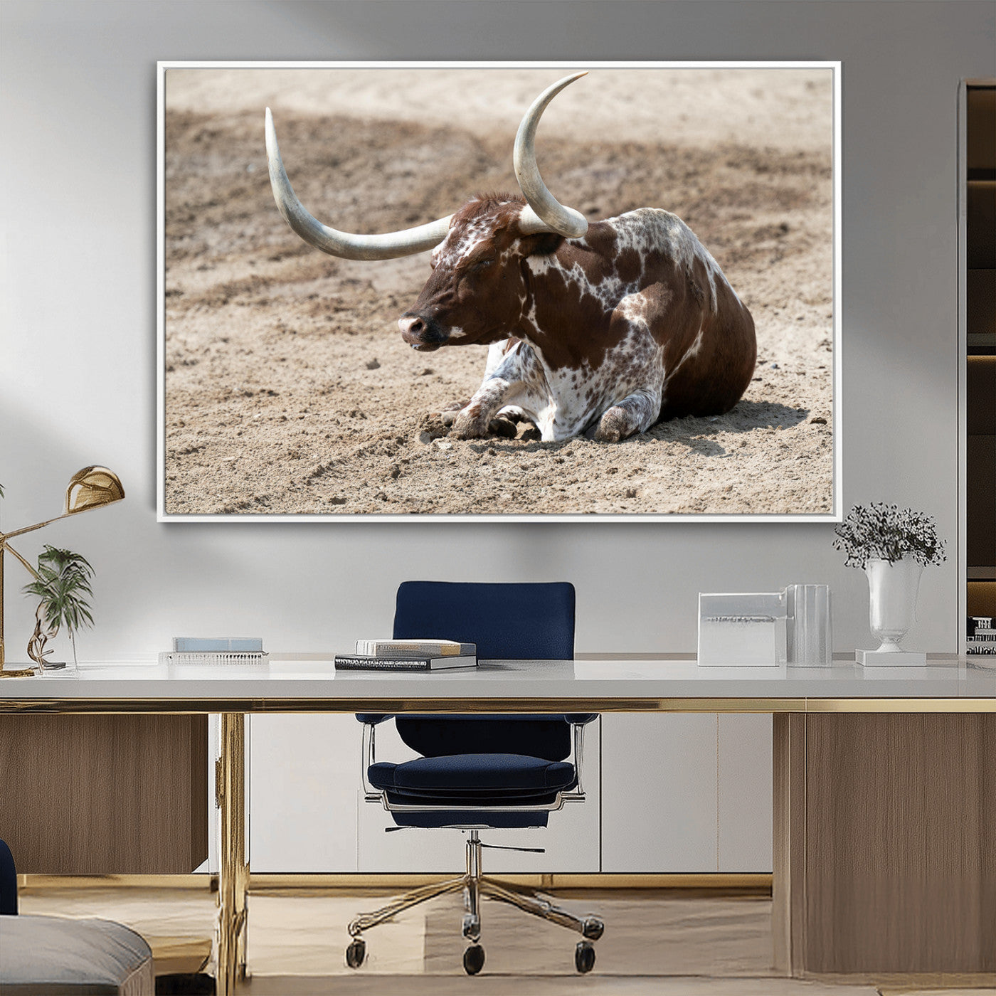 Texas Longhorn resting on sandy ground with large curved horns, capturing a rustic Western aesthetic perfect for farmhouse-style wall art.