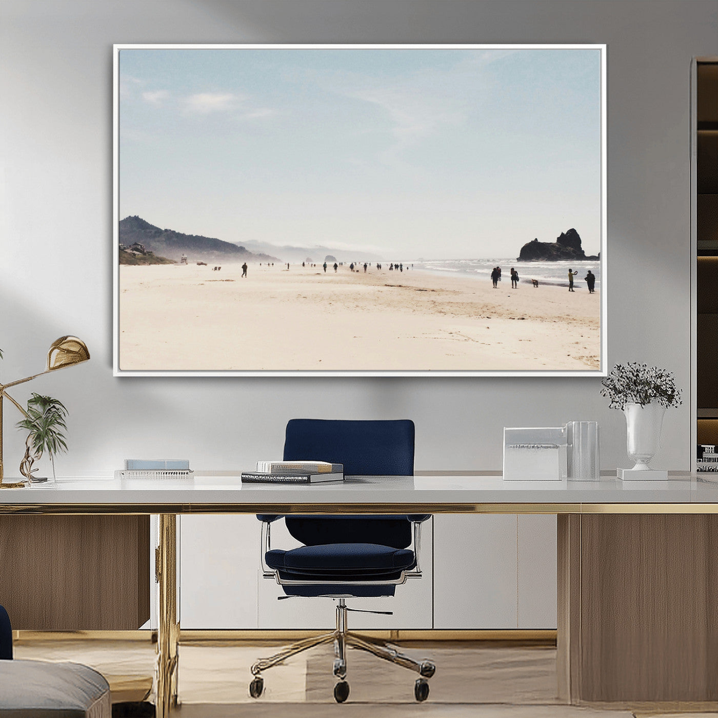 A serene beach with soft sand, misty mountains, and scattered people walking along the shoreline, creating a peaceful coastal landscape.