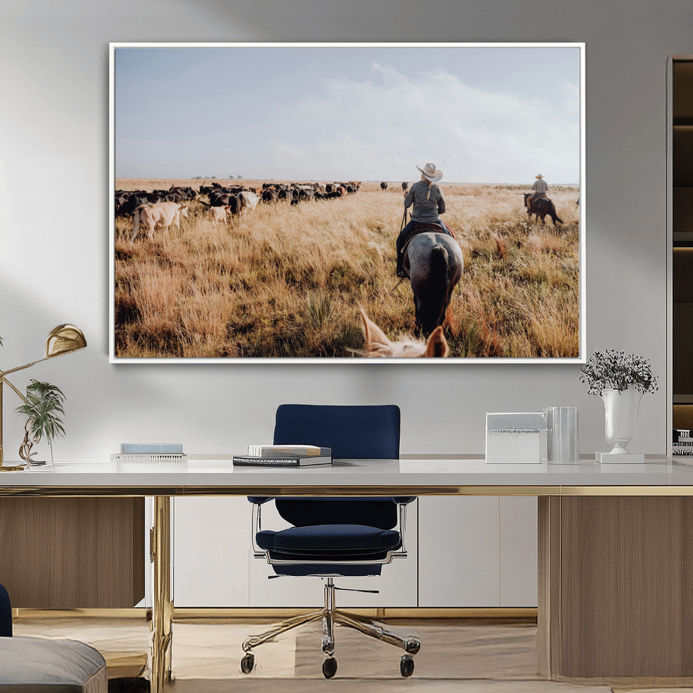 A cowboy and cowgirl on horseback herding cattle through golden grasslands, capturing a rustic and authentic Western ranch lifestyle.