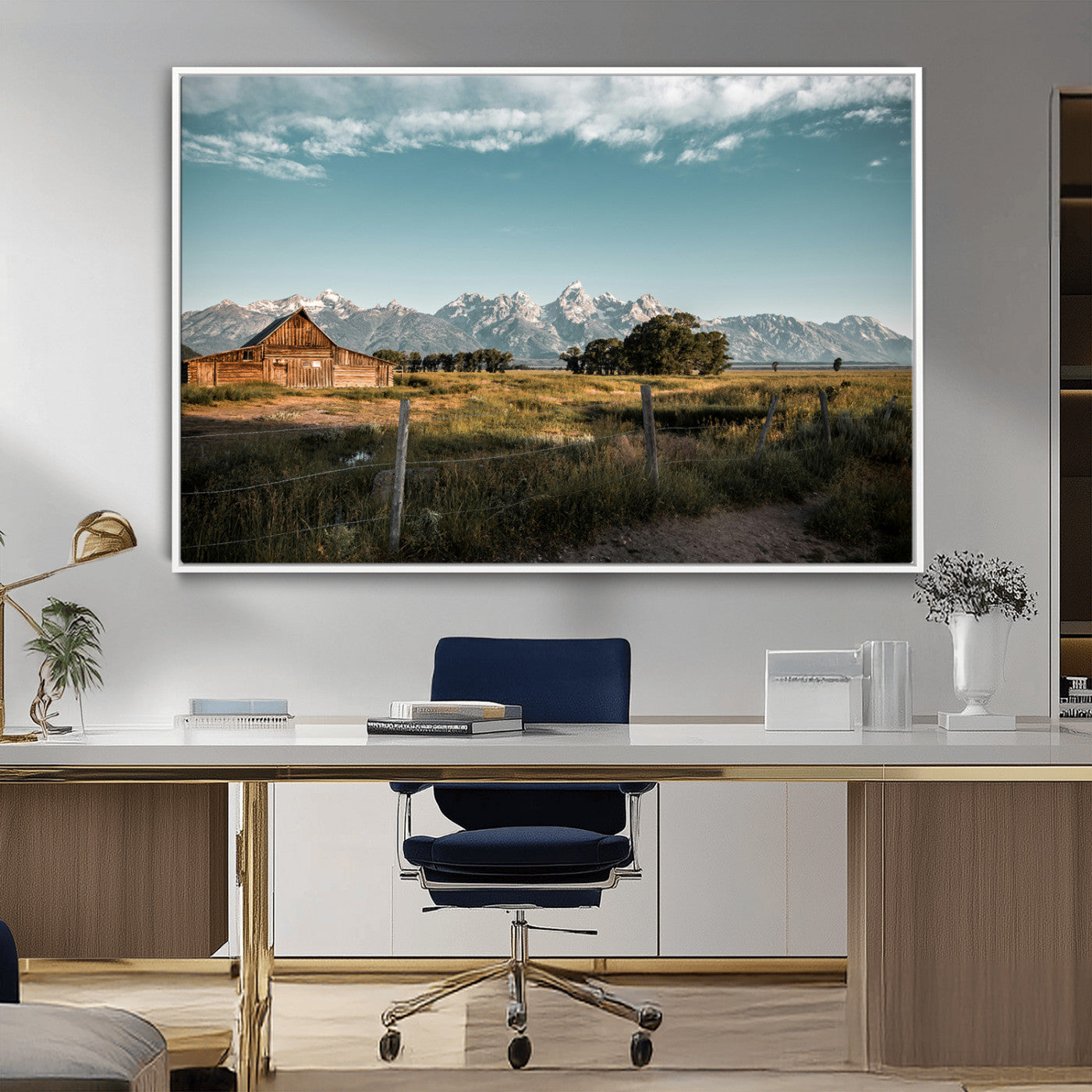 A rustic farmhouse with a wooden barn set against majestic mountain peaks under a soft blue sky, evoking peaceful countryside charm.