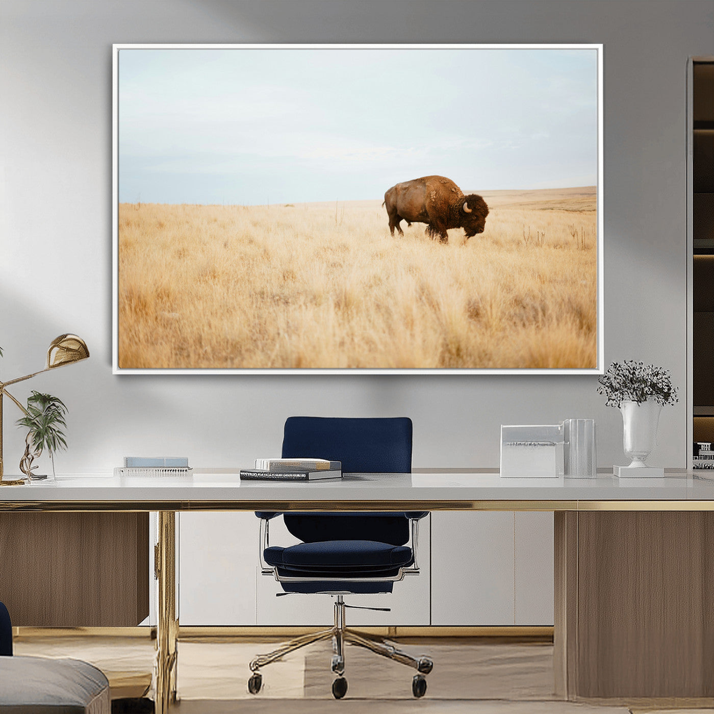 A lone bison standing in a vast golden grassland under a soft blue sky, evoking a rustic and Western aesthetic, ideal for farmhouse decor.