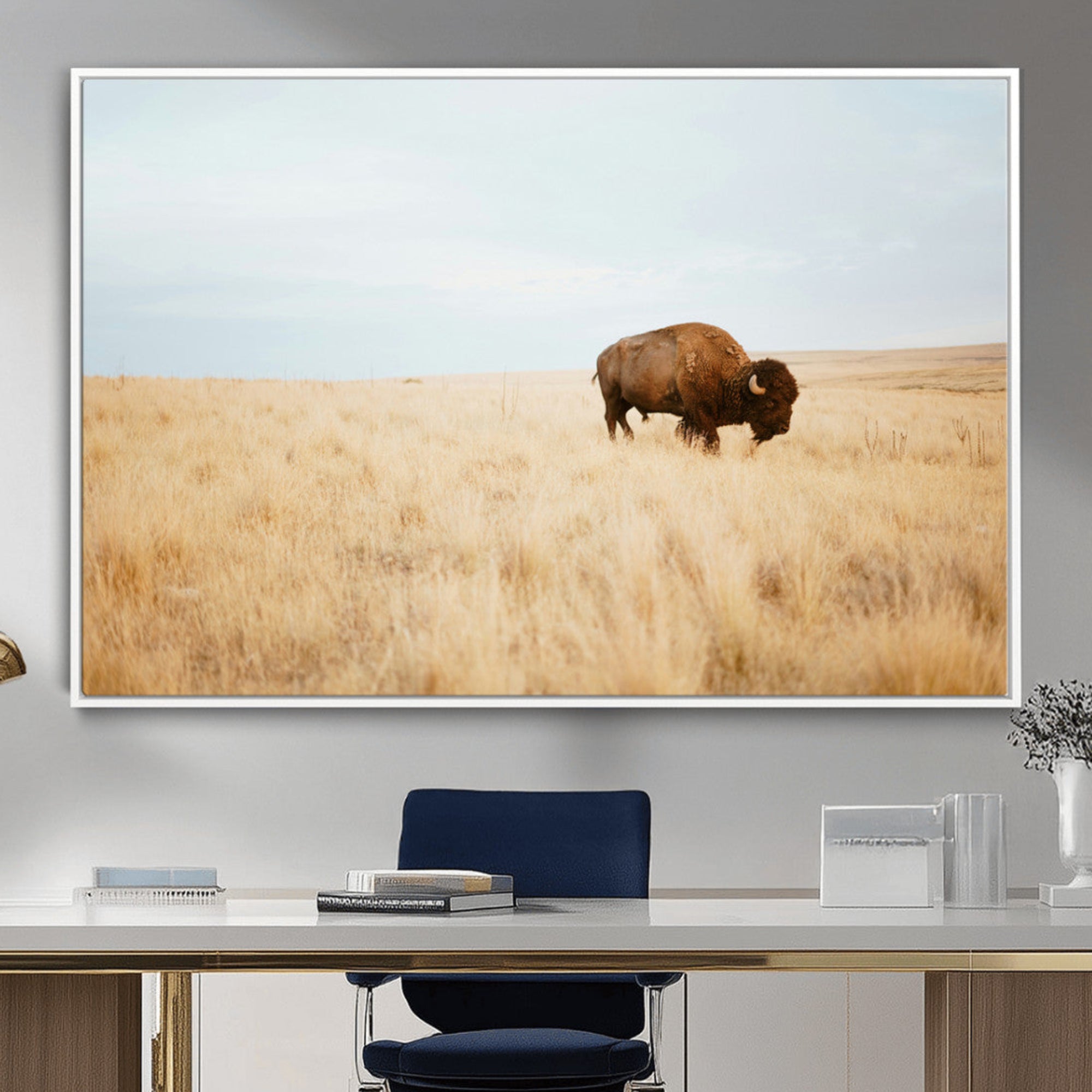 A lone bison standing in a vast golden grassland under a soft blue sky, evoking a rustic and Western aesthetic, ideal for farmhouse decor.