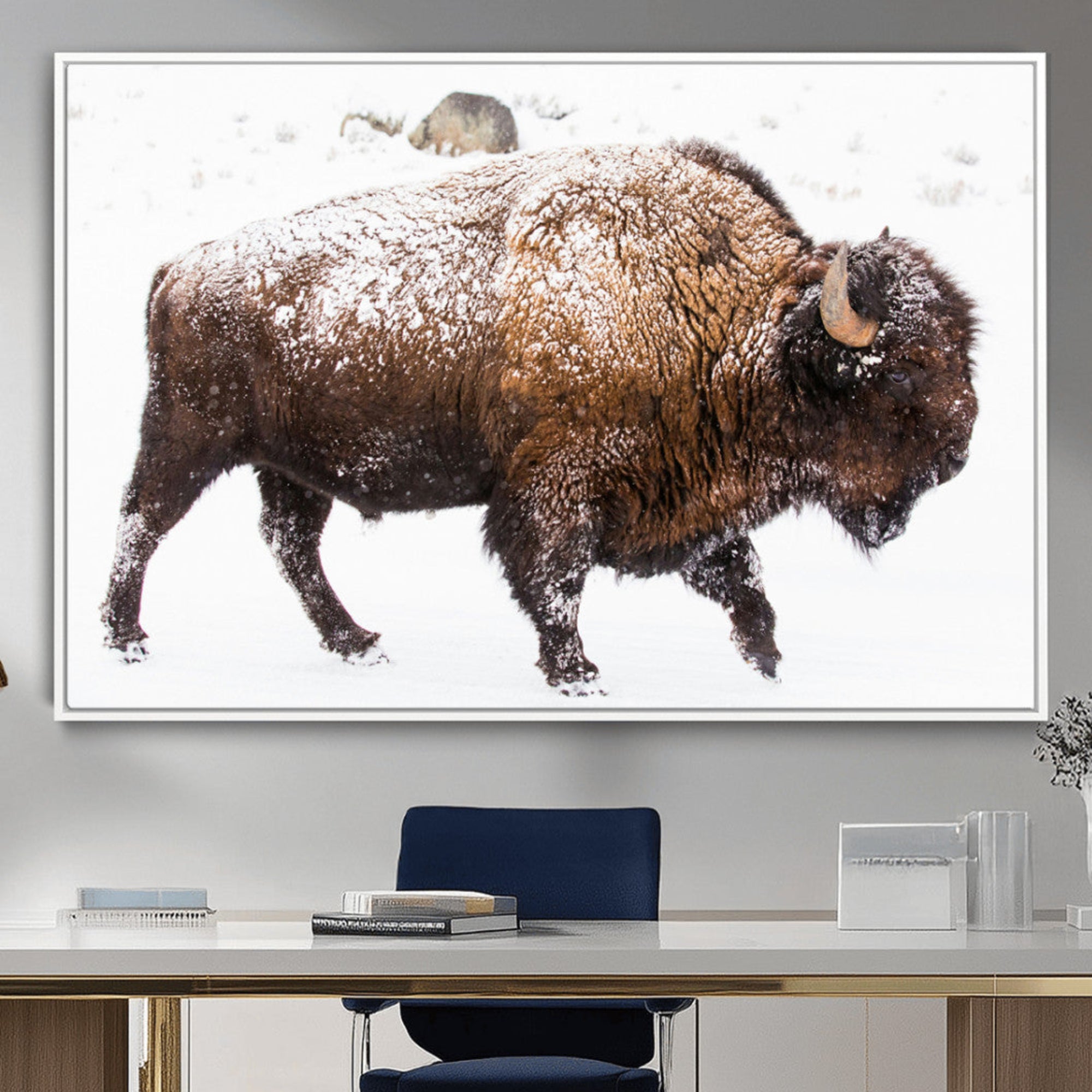 Side profile of a powerful bison walking through deep snow, with frost-covered fur and a white winter background, perfect for rustic and western decor.