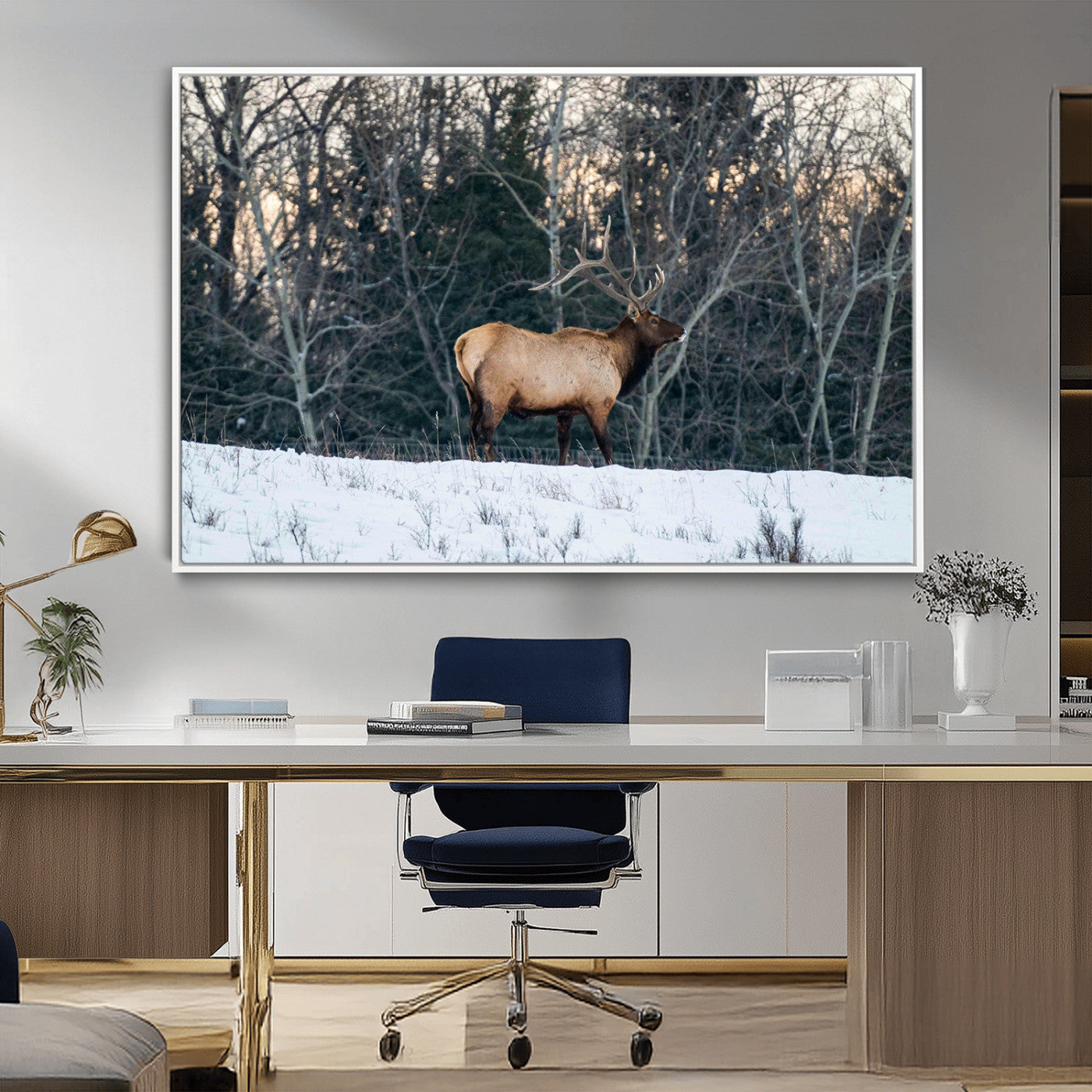 A majestic elk with large antlers standing in a snowy field against a winter forest backdrop, perfect for rustic and wildlife-themed home decor.