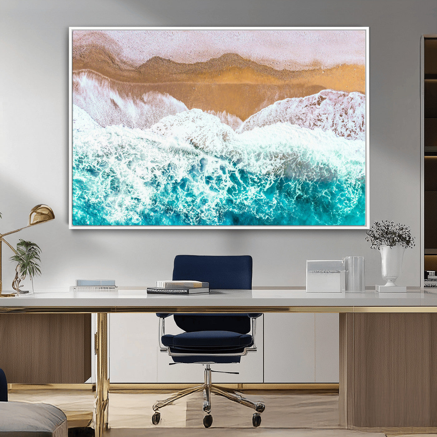 Aerial view of ocean waves crashing onto a sandy beach, with turquoise water and foamy white surf, creating a serene coastal aesthetic for home decor.