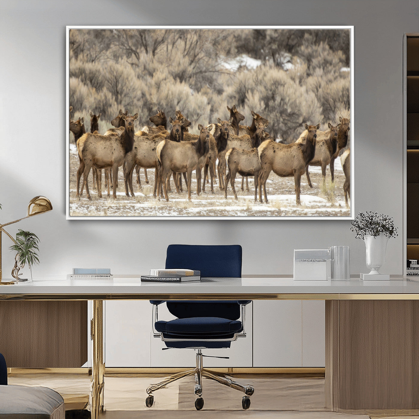 A stunning wall art canvas print featuring a large herd of elk standing together in a natural winter landscape with muted earthy tones and soft background foliage, perfect for rustic or nature-inspired home decor.