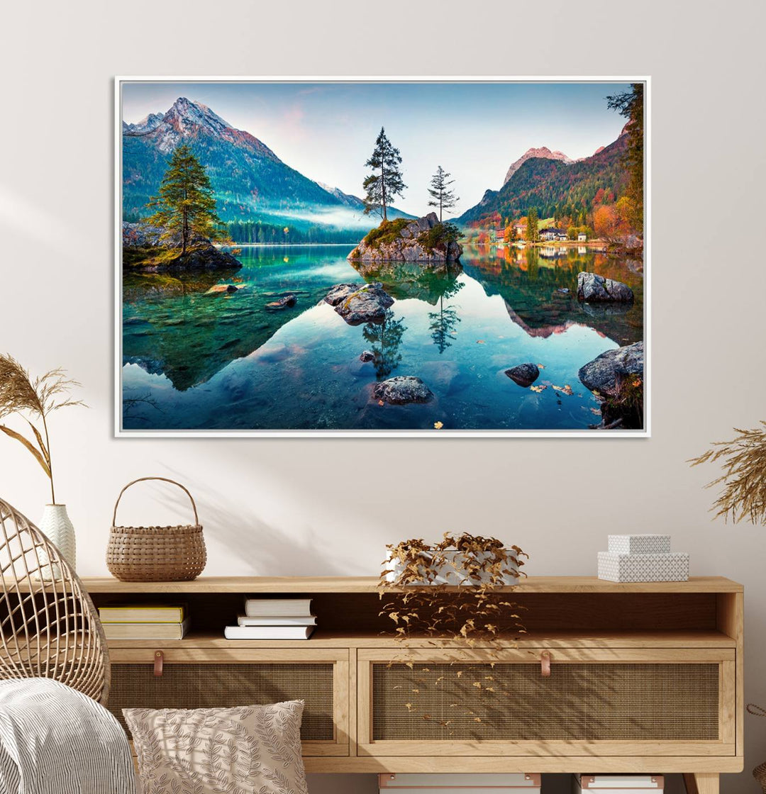 The 3-panel wall art showcases a serene mountain lake with rocky islands and trees, creating an ideal focal point for dining rooms or offices.