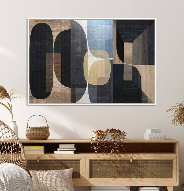 Abstract geometric wall art featuring black, gray, beige, and blue tones framed in a wooden border.