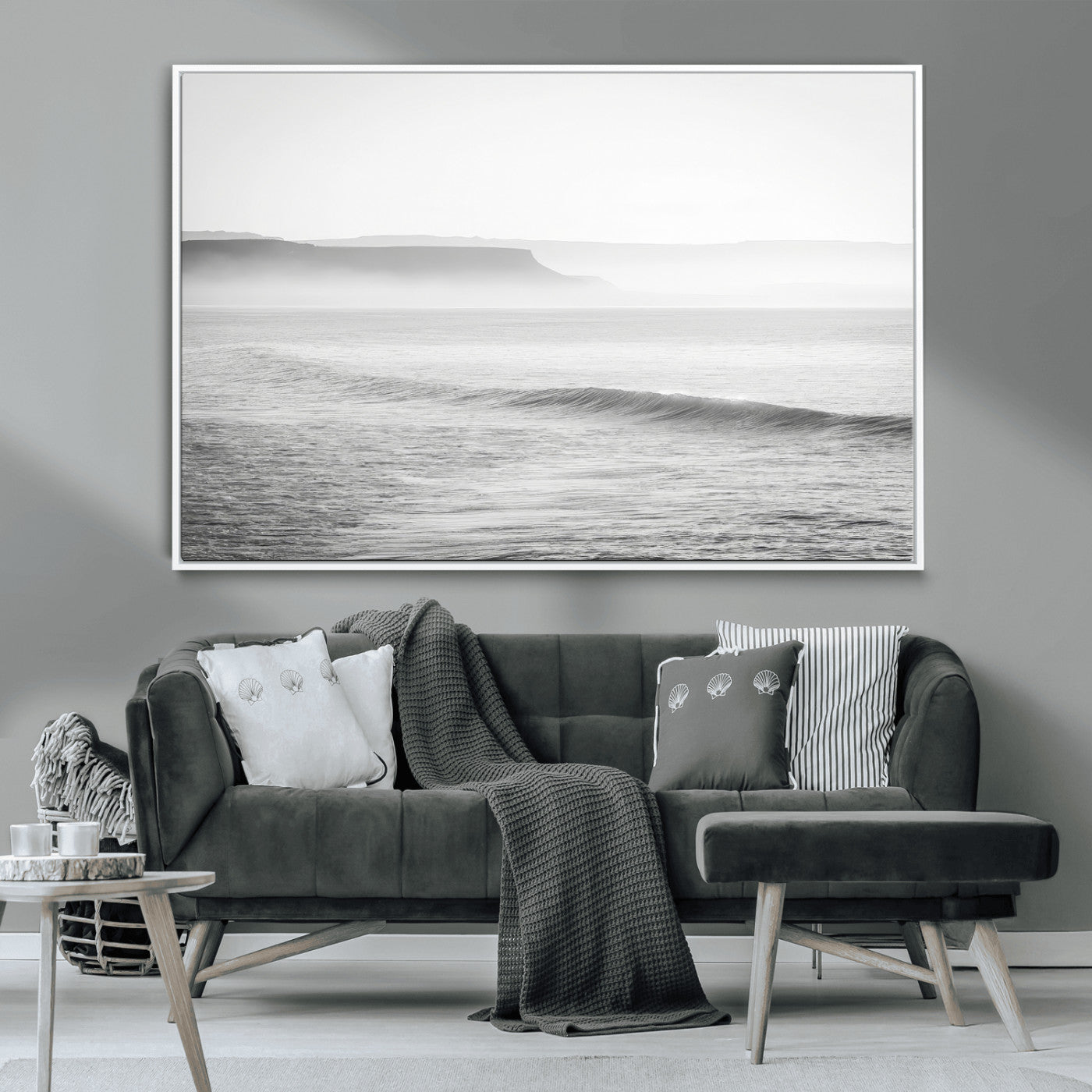 A black and white minimalist seascape featuring soft rolling waves and misty distant cliffs, creating a serene and timeless coastal atmosphere.