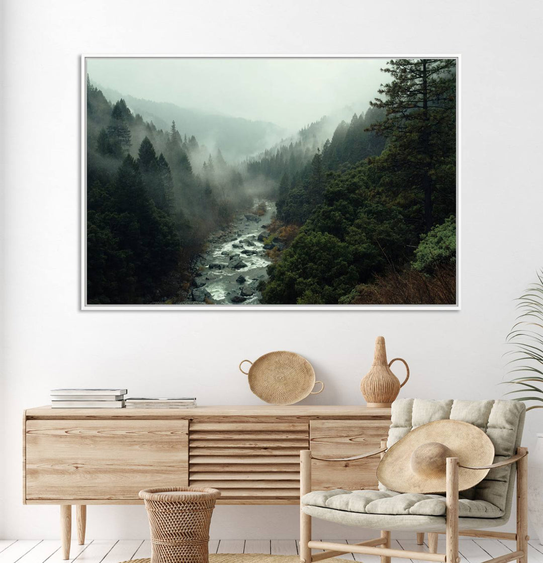 The Misty Forest Wall Art features a serene landscape with a misty river and evergreens, ideal for enhancing the ambiance of any living room or cabin.