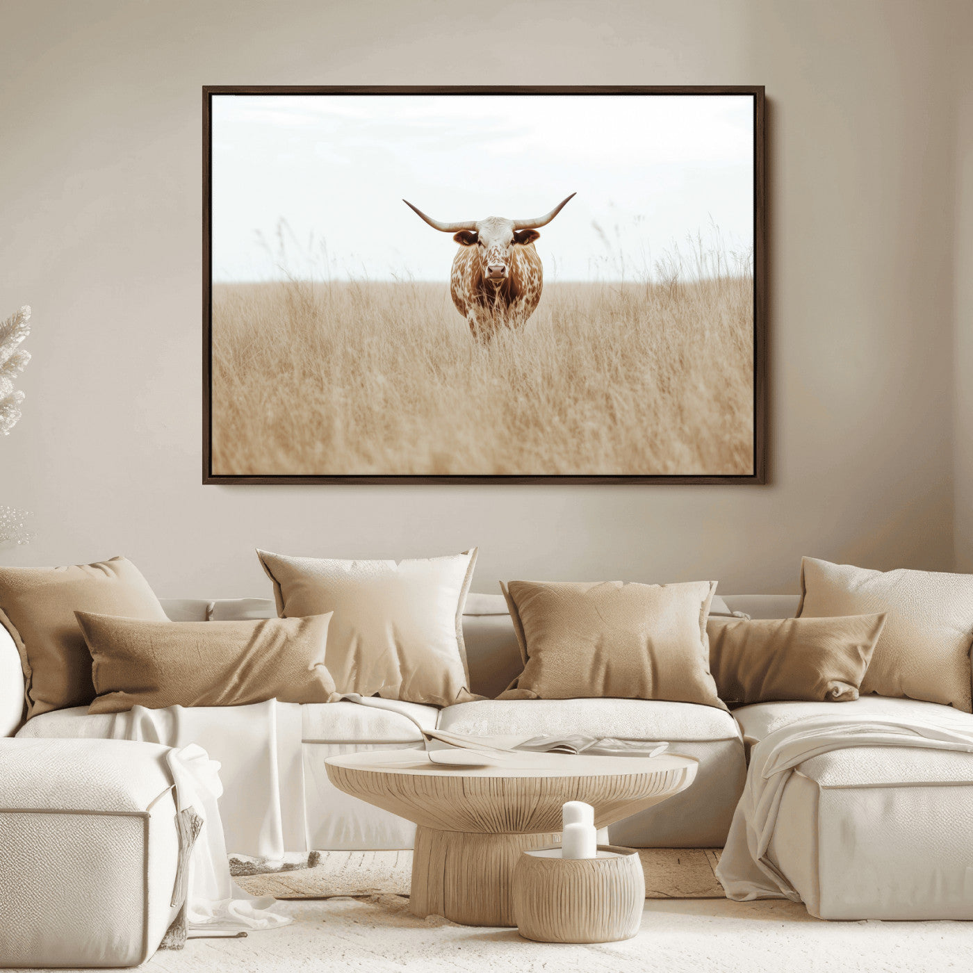 Texas Longhorn bull standing alone in dry grass with neutral tones, ideal for rustic western or cowboy-themed wall decor.