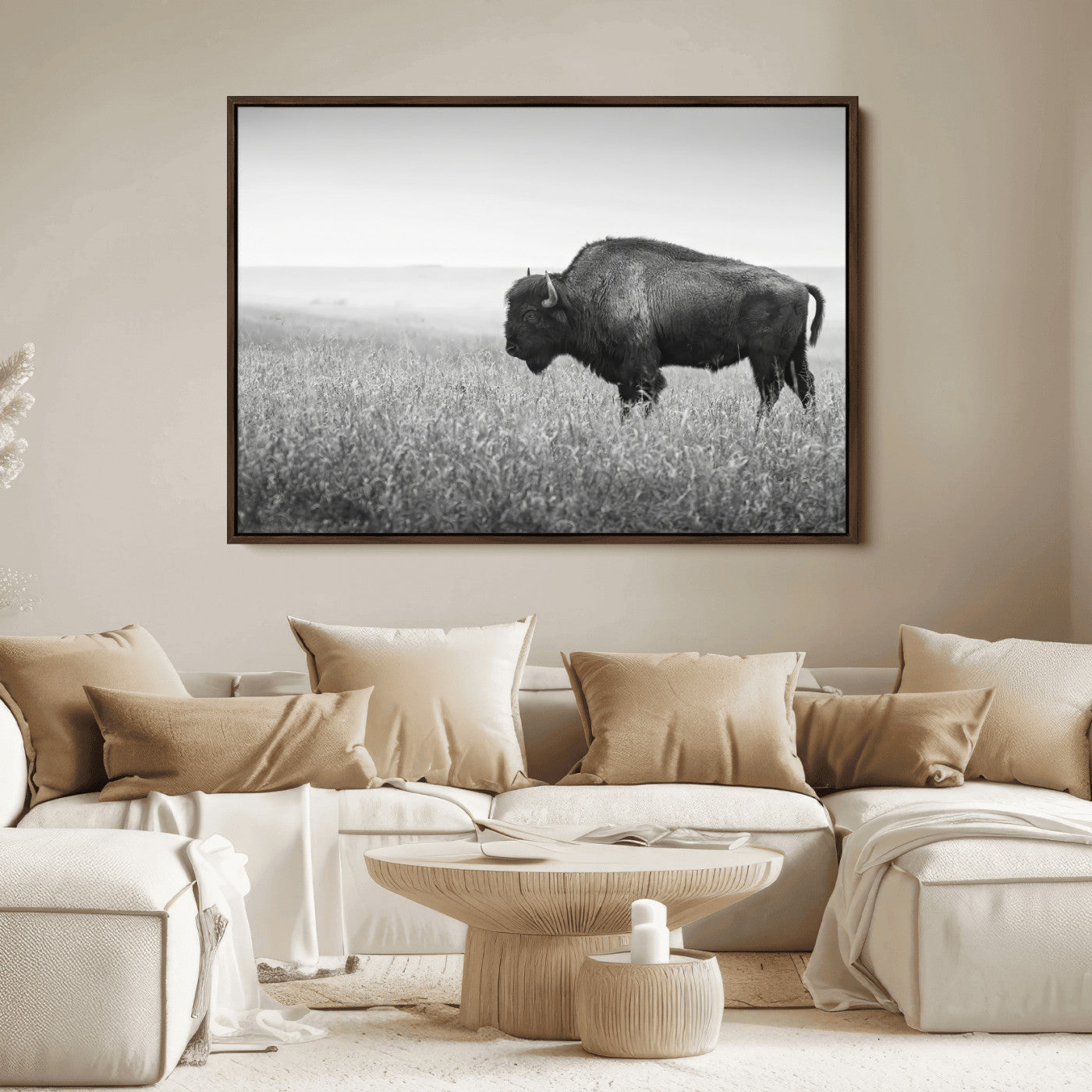 A black and white photograph of a majestic bison standing in a vast grassy prairie, evoking a sense of wilderness and strength.