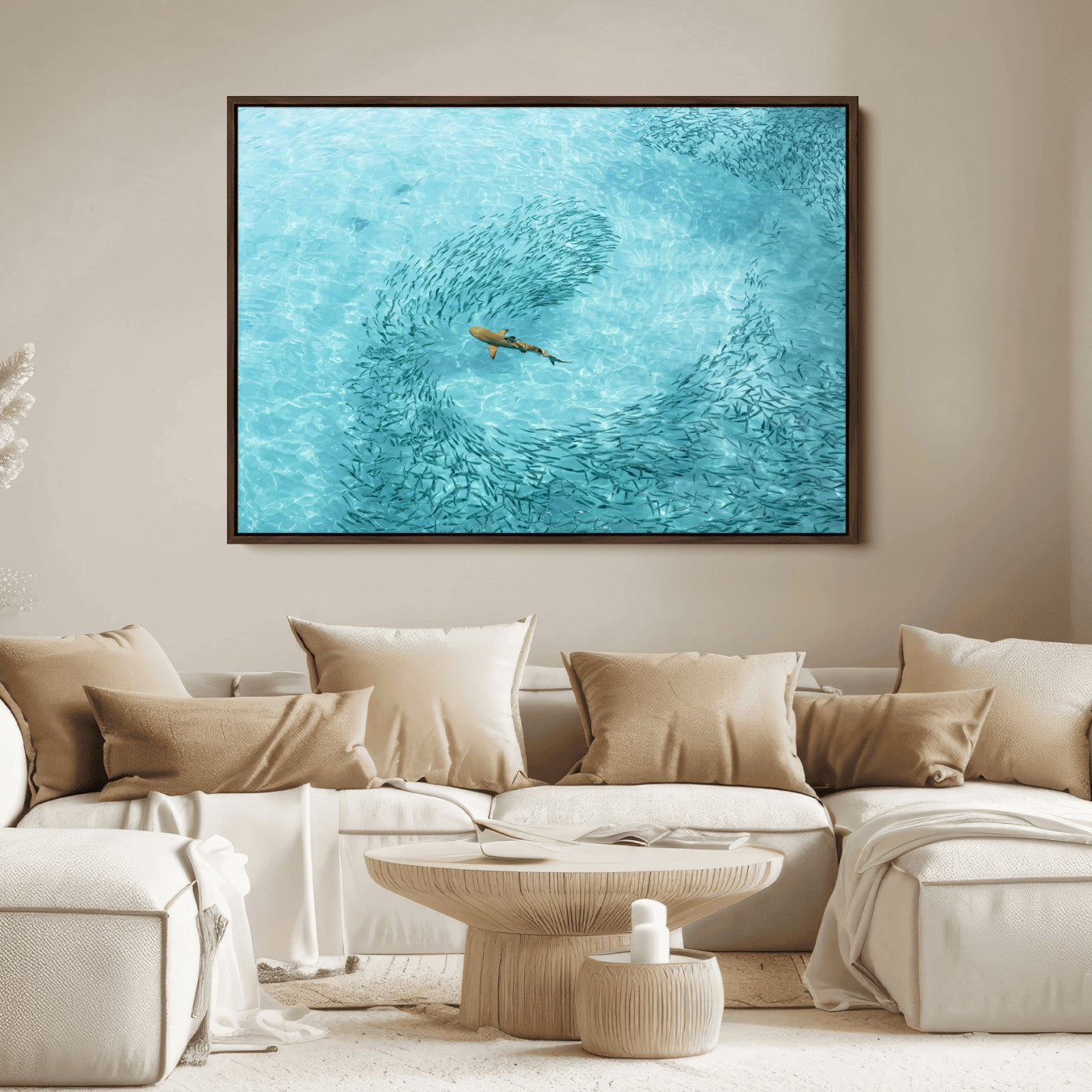 Aerial view of a shark swimming through a swirl of fish in clear turquoise waters, perfect for calm coastal or beach house decor.