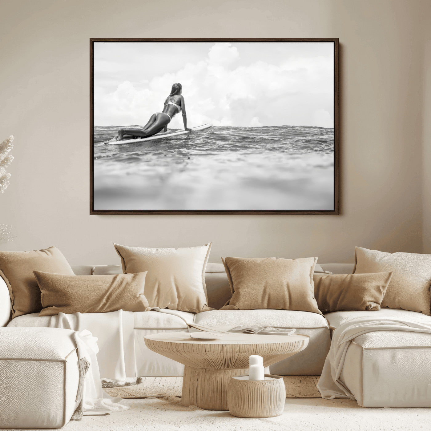 A black and white ocean scene featuring a surfer girl waiting on her board, gazing at the horizon, capturing a tranquil and adventurous coastal moment.