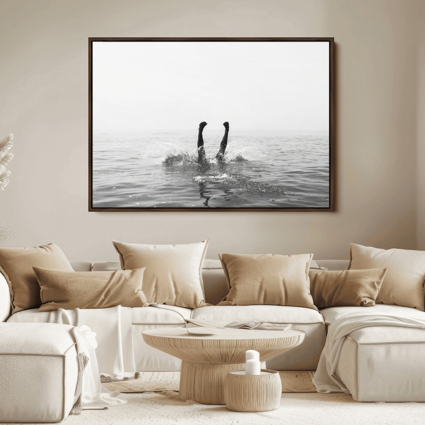 A black and white minimalist water scene capturing a playful splash as a swimmer dives upside down, creating a carefree and artistic aquatic aesthetic.