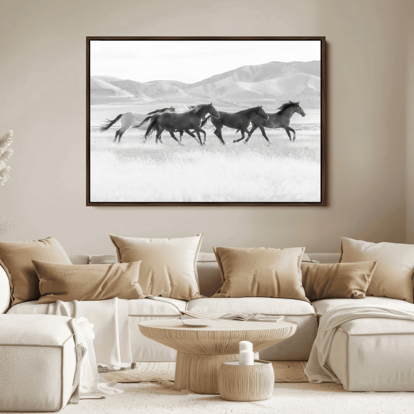A black and white image of wild horses running freely across an open grassland, capturing the power and beauty of untamed nature in a rustic western setting.