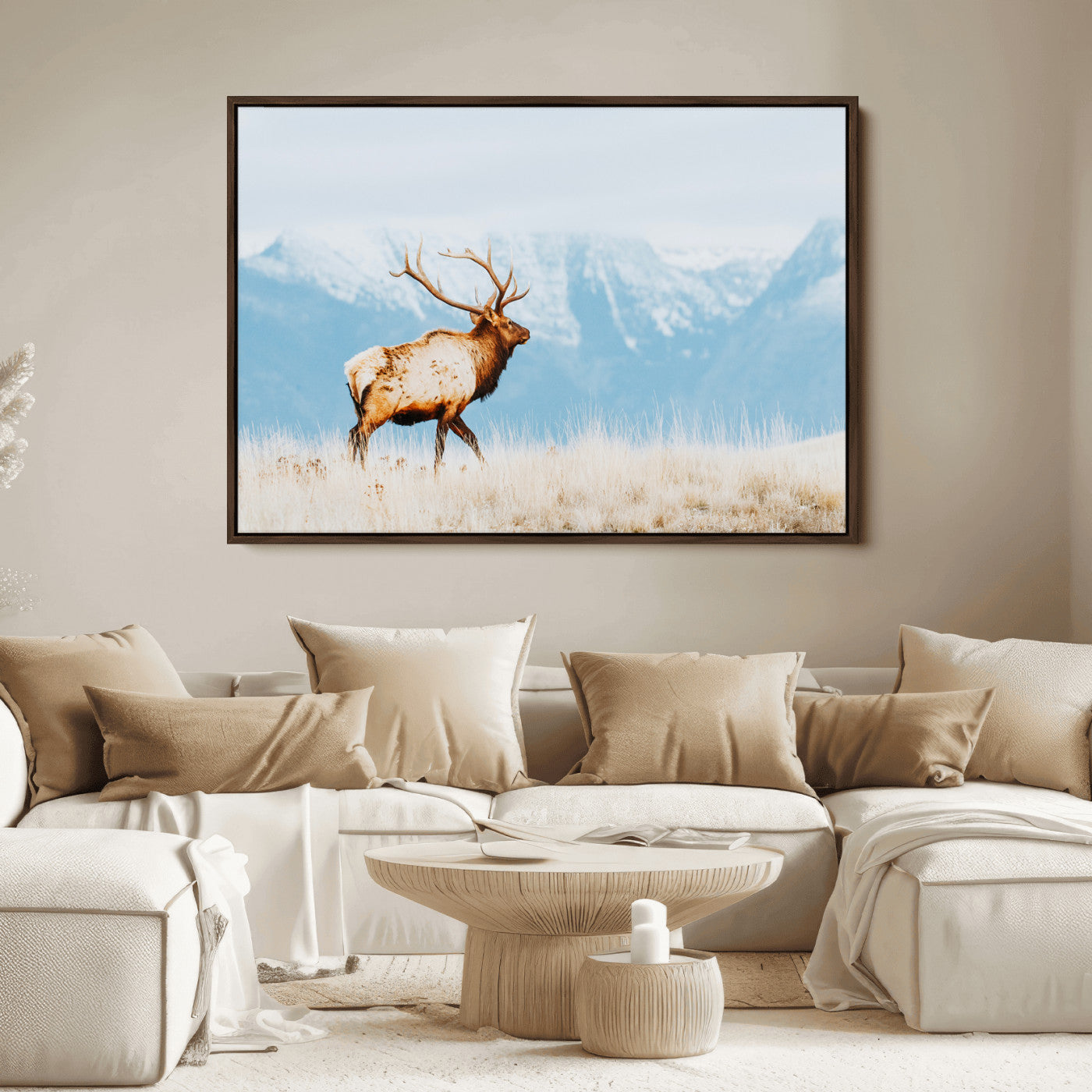 Majestic elk standing on dry grassland with snowy mountains in the background, ideal for rustic or lodge-inspired wall decor.
