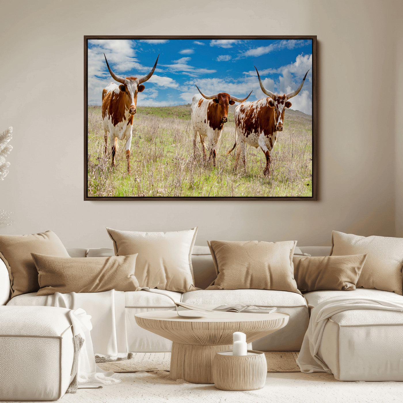 Three Texas longhorn cattle standing in dry grass under a bright blue sky, ideal for farmhouse or western rustic home decor.