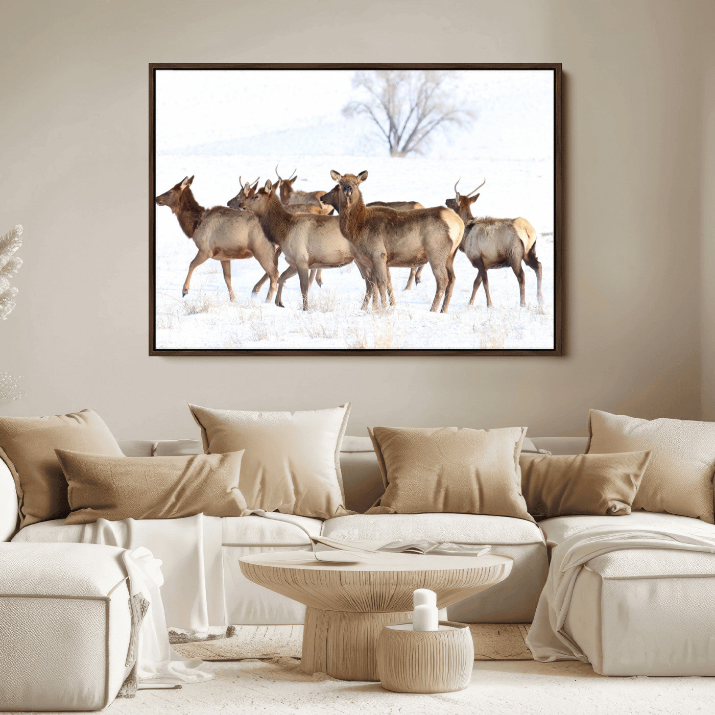 A group of elk standing on snowy terrain with a tree in the background, perfect for rustic or lodge-style winter wall decor.