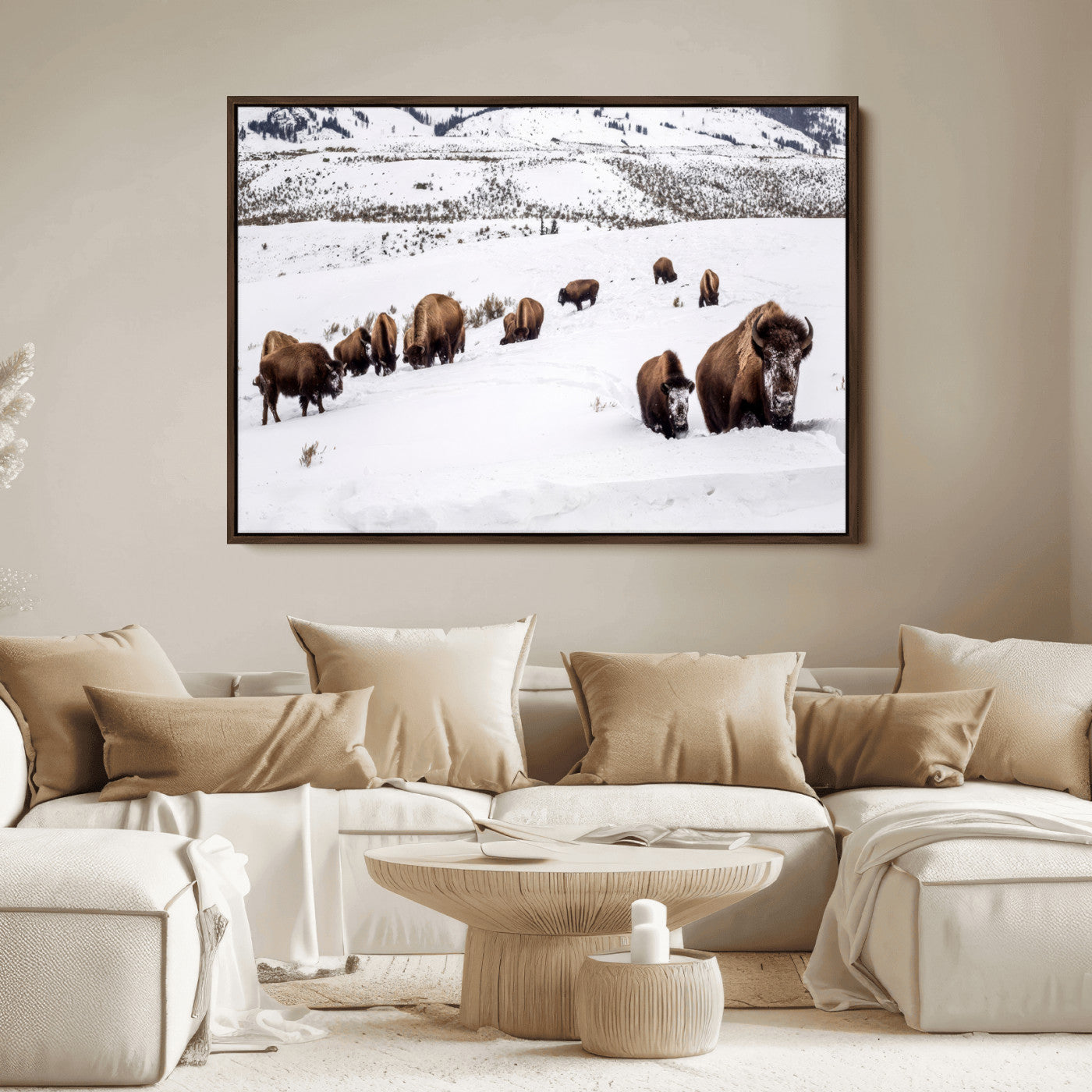 A herd of bison walking through deep snow in a mountain valley, perfect for rustic, cabin or western-themed wall decor.