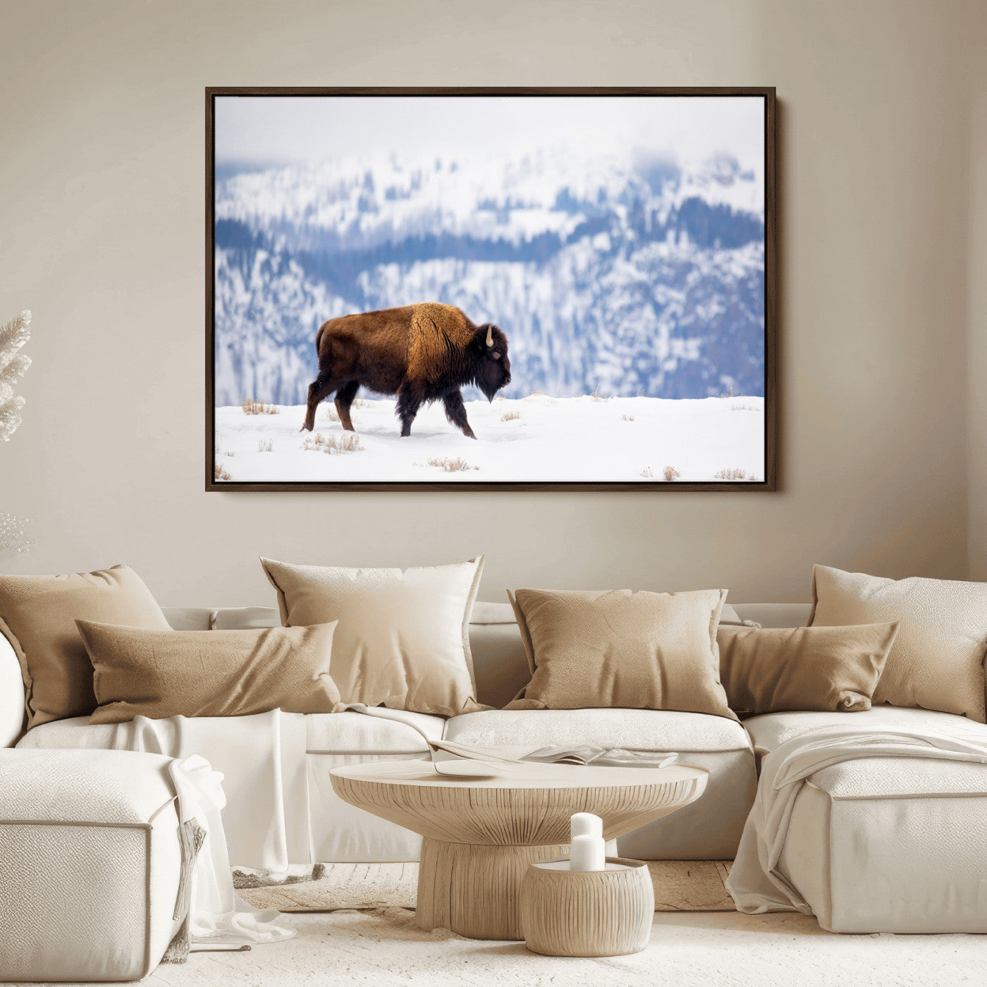 A lone bison walks across snowy ground with blue-toned mountain range behind, ideal for rustic or western farmhouse interiors.