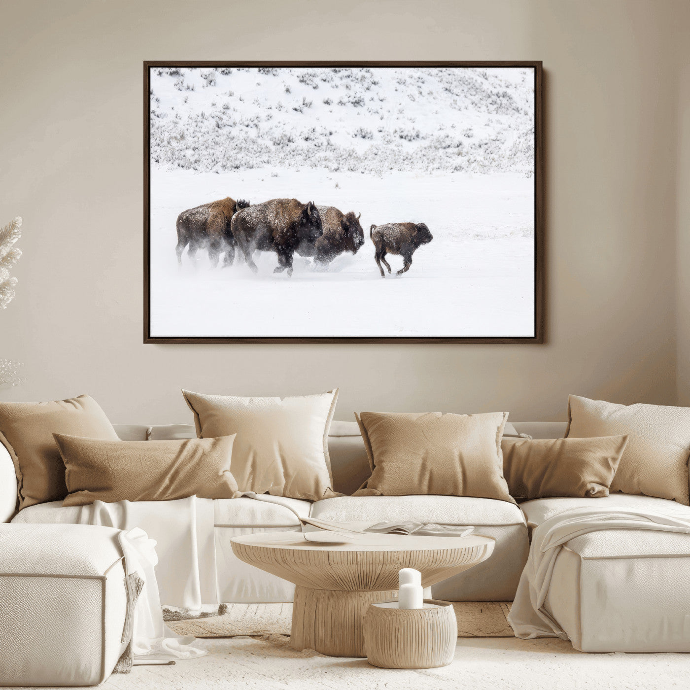 Bison herd running through a snowy open field with mountain backdrop, perfect for rustic or western-themed wall decoration.