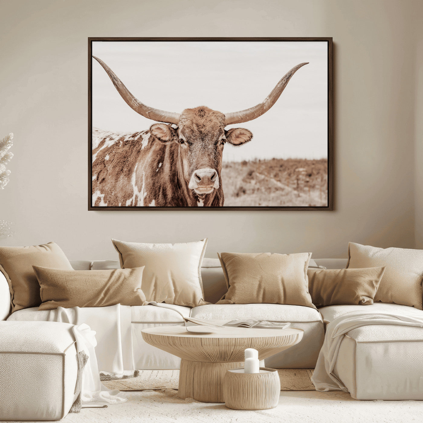 A longhorn cow in soft beige desert tones, standing calmly in open land, perfect for neutral western or rustic farmhouse interiors.