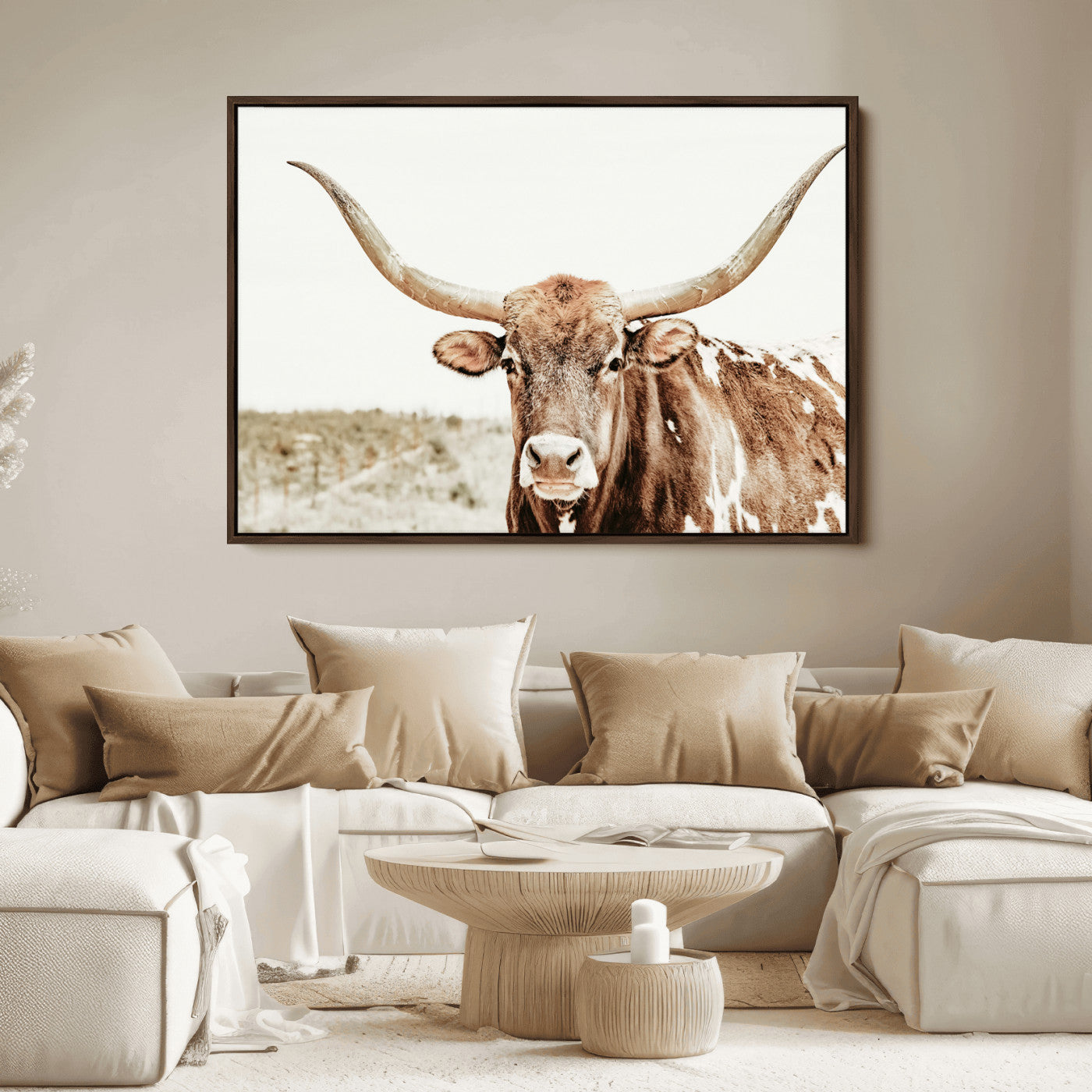 A Texas longhorn bull with wide horns, standing in a dry field under soft light, ideal for rustic farmhouse or western-themed interiors.