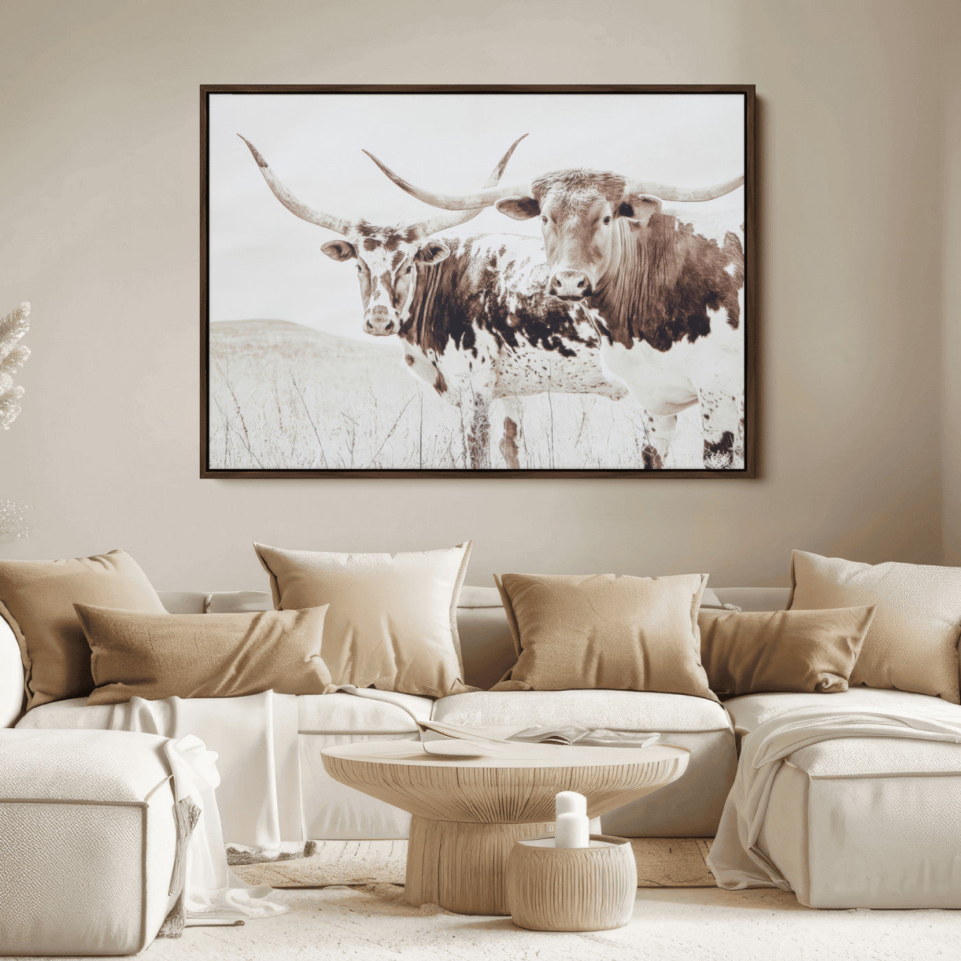 Two longhorn cattle standing in a dry grassy field with neutral tones, creating a rustic and farmhouse-inspired Western aesthetic.