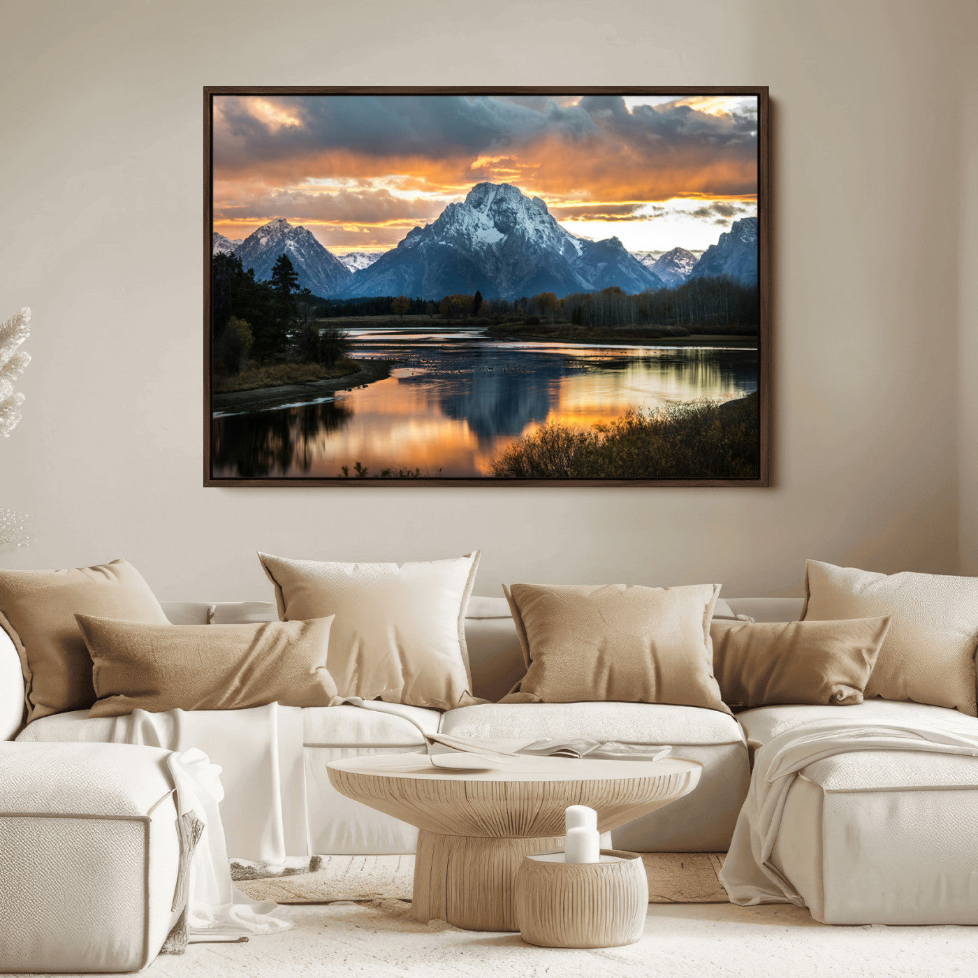 Snow-capped mountains reflecting in a calm lake at sunset, with a dramatic golden sky creating a breathtaking wilderness scene.