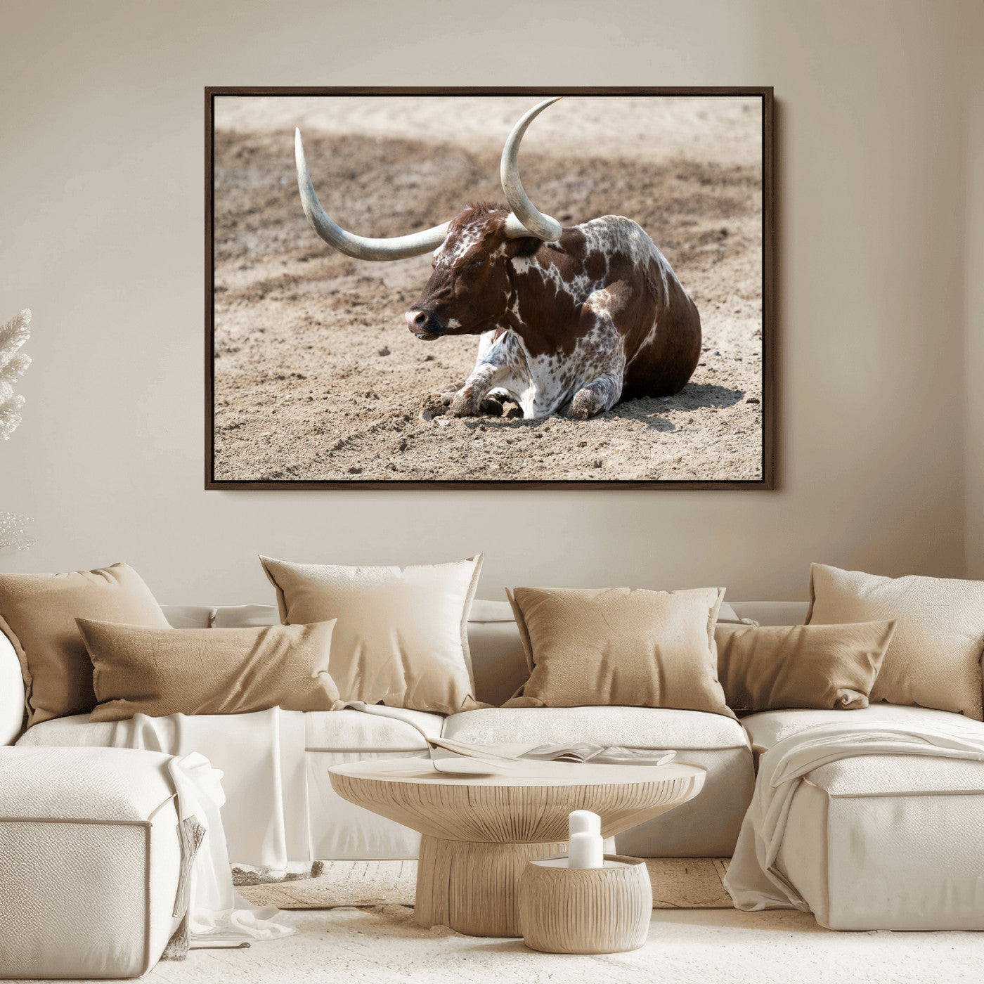 Texas Longhorn resting on sandy ground with large curved horns, capturing a rustic Western aesthetic perfect for farmhouse-style wall art.