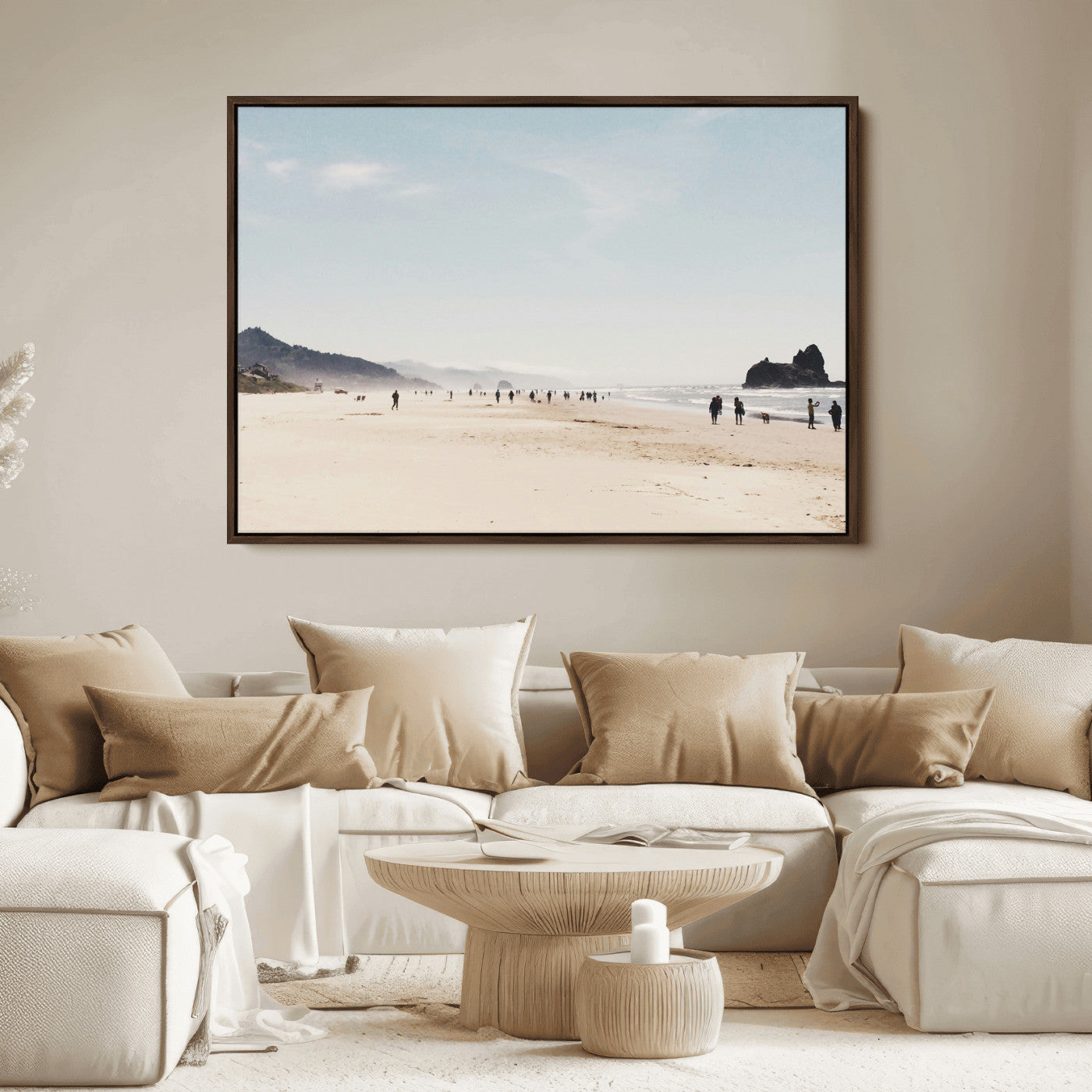 A serene beach with soft sand, misty mountains, and scattered people walking along the shoreline, creating a peaceful coastal landscape.