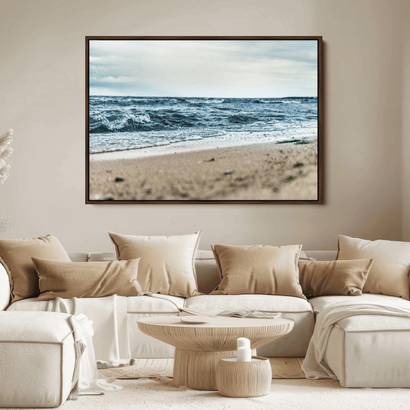 A moody ocean scene with gentle waves washing onto a sandy beach under a cloudy sky, creating a peaceful and coastal atmosphere.