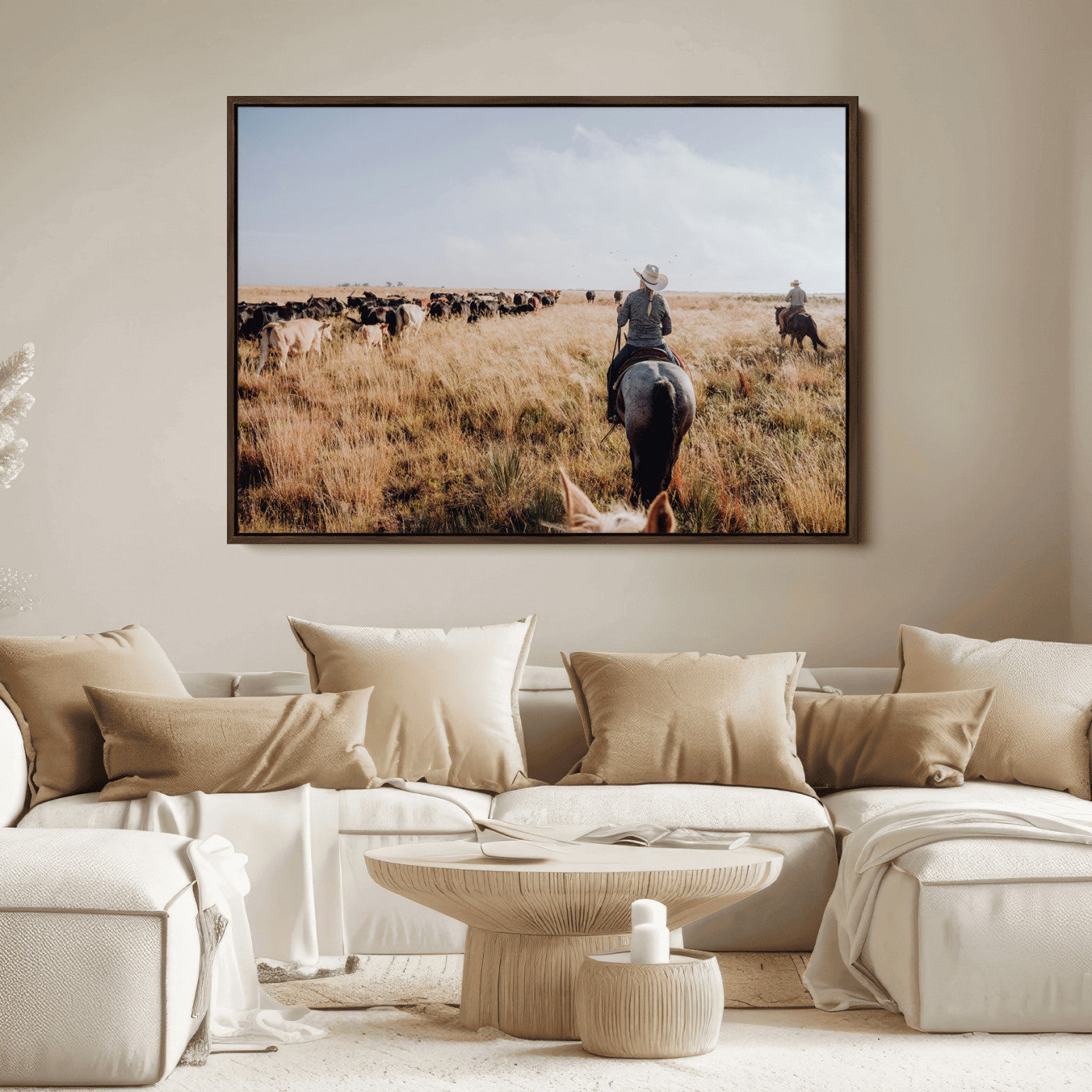 A cowboy and cowgirl on horseback herding cattle through golden grasslands, capturing a rustic and authentic Western ranch lifestyle.