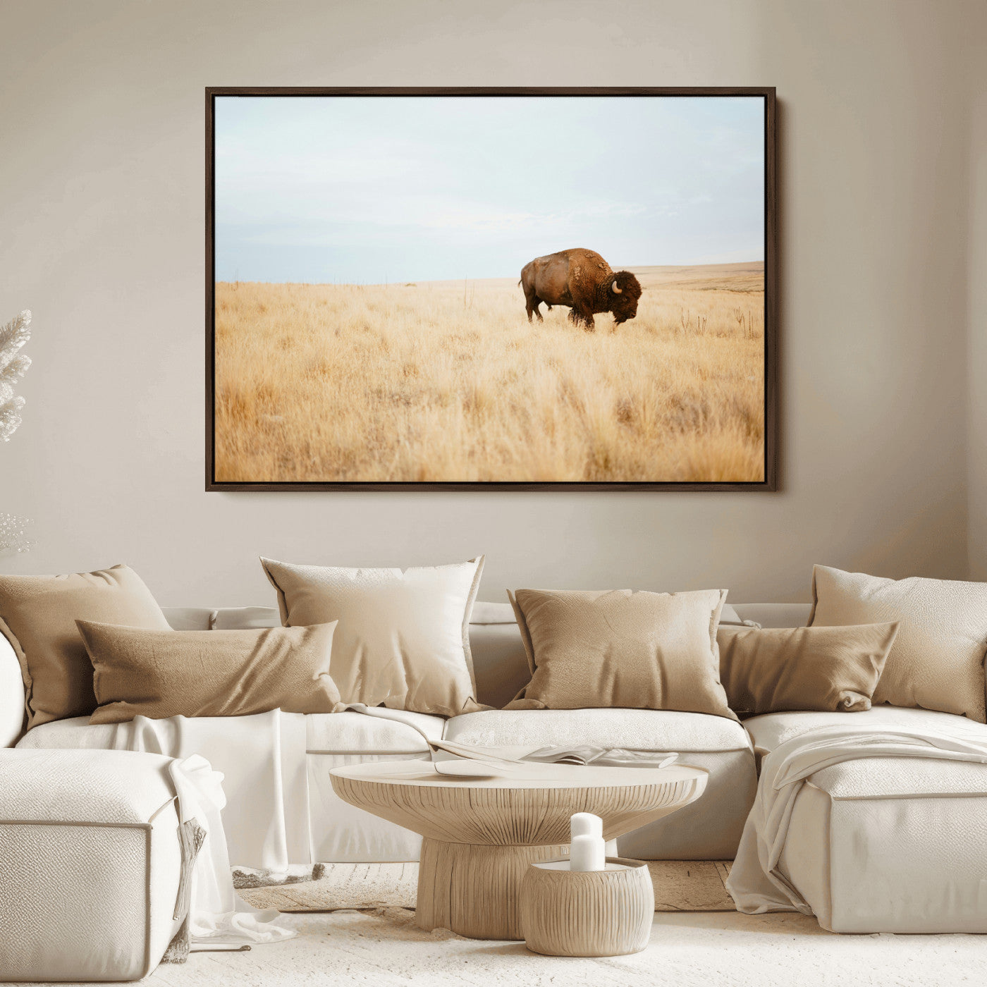 A lone bison standing in a vast golden grassland under a soft blue sky, evoking a rustic and Western aesthetic, ideal for farmhouse decor.
