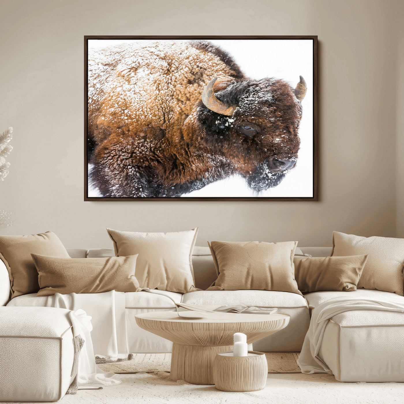Close-up photograph of a bison covered in snow, highlighting its thick fur and powerful presence, set against a white winter backdrop, ideal for rustic decor.