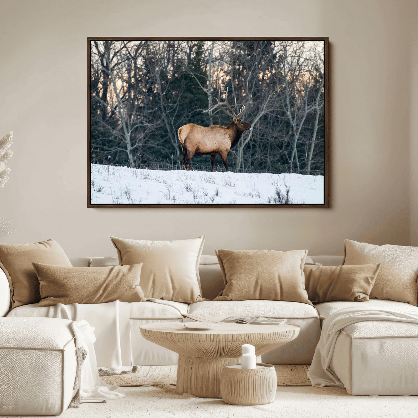 A majestic elk with large antlers standing in a snowy field against a winter forest backdrop, perfect for rustic and wildlife-themed home decor.