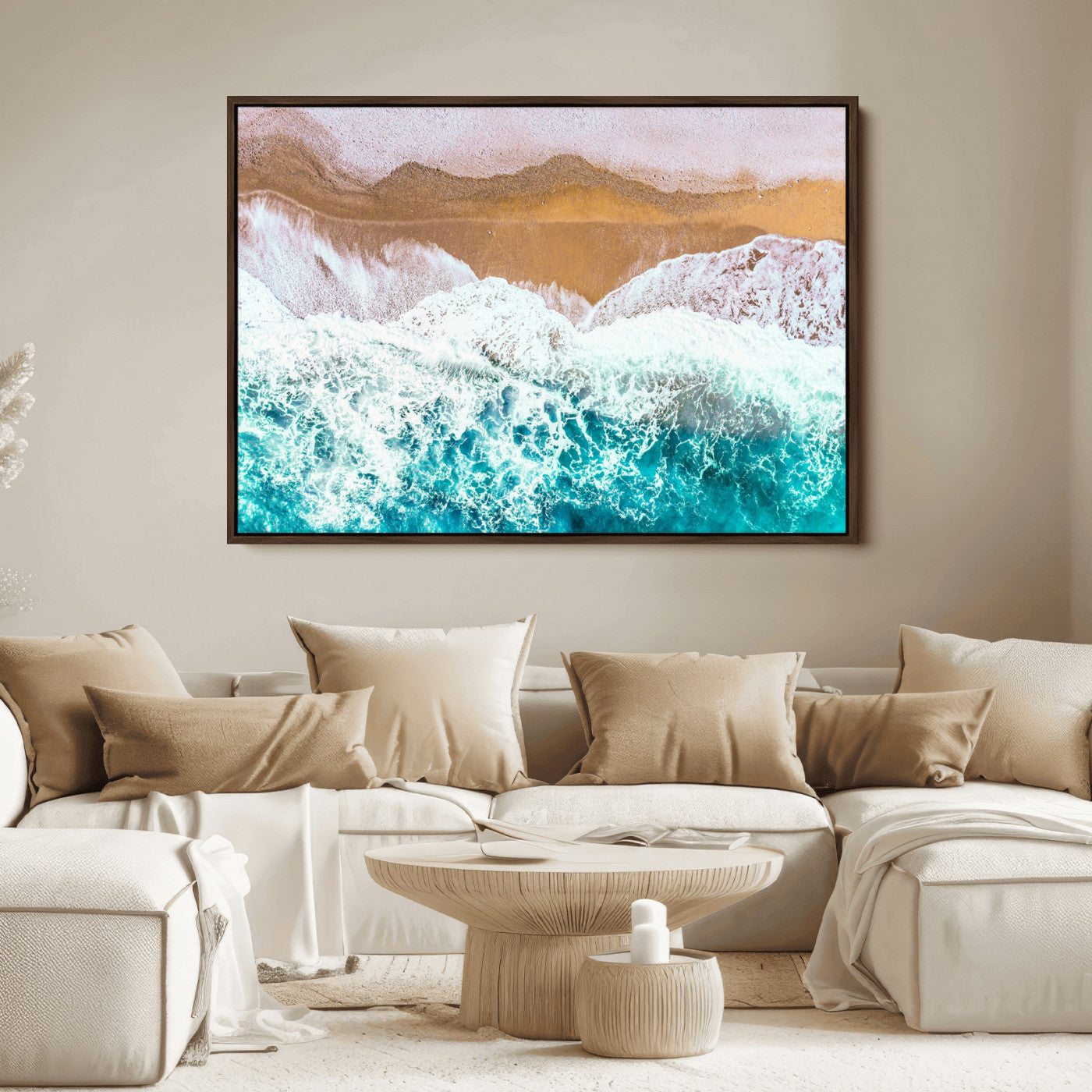 Aerial view of ocean waves crashing onto a sandy beach, with turquoise water and foamy white surf, creating a serene coastal aesthetic for home decor.