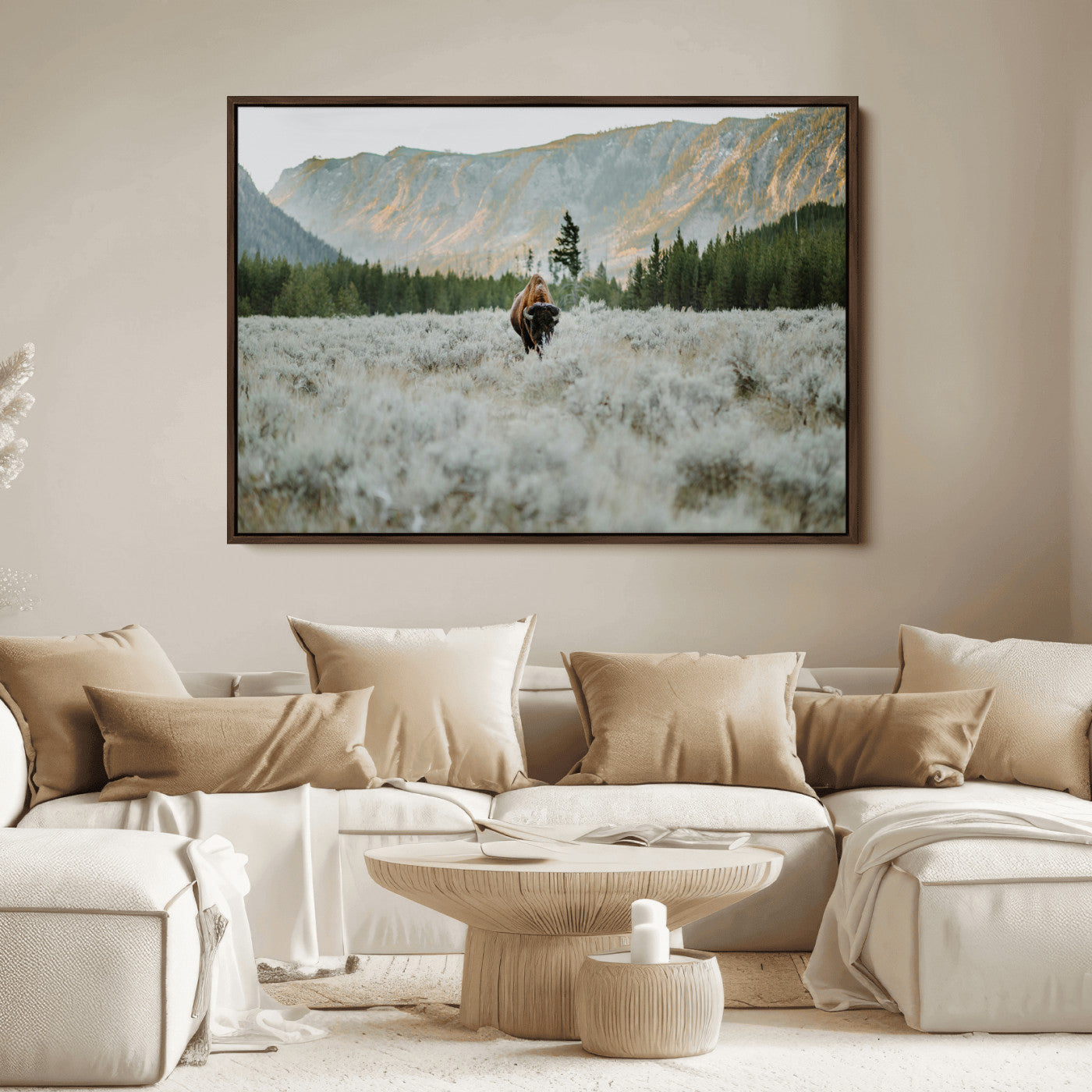 Lone bison standing in a frosted sagebrush field with a pine forest and rugged mountain range in the background under soft morning light – Wall Art Canvas Print.