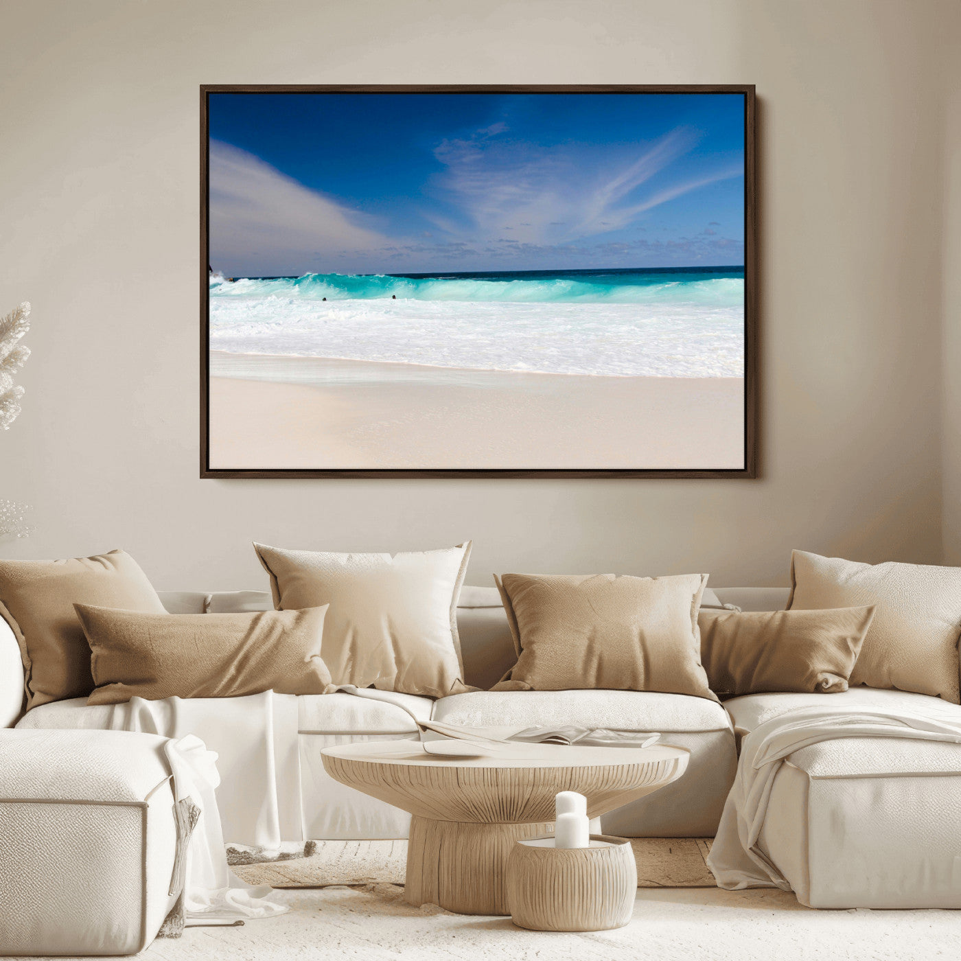 Turquoise waves crash onto a pristine white sand beach under a vivid blue sky with wispy clouds, creating a peaceful and refreshing coastal scene.