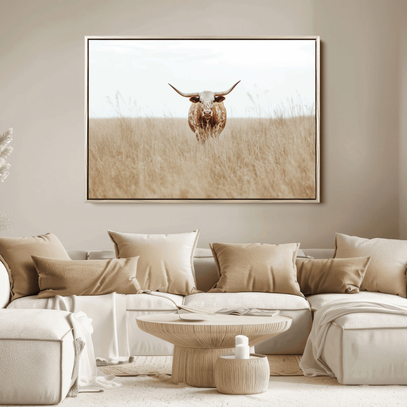 Texas Longhorn bull standing alone in dry grass with neutral tones, ideal for rustic western or cowboy-themed wall decor.