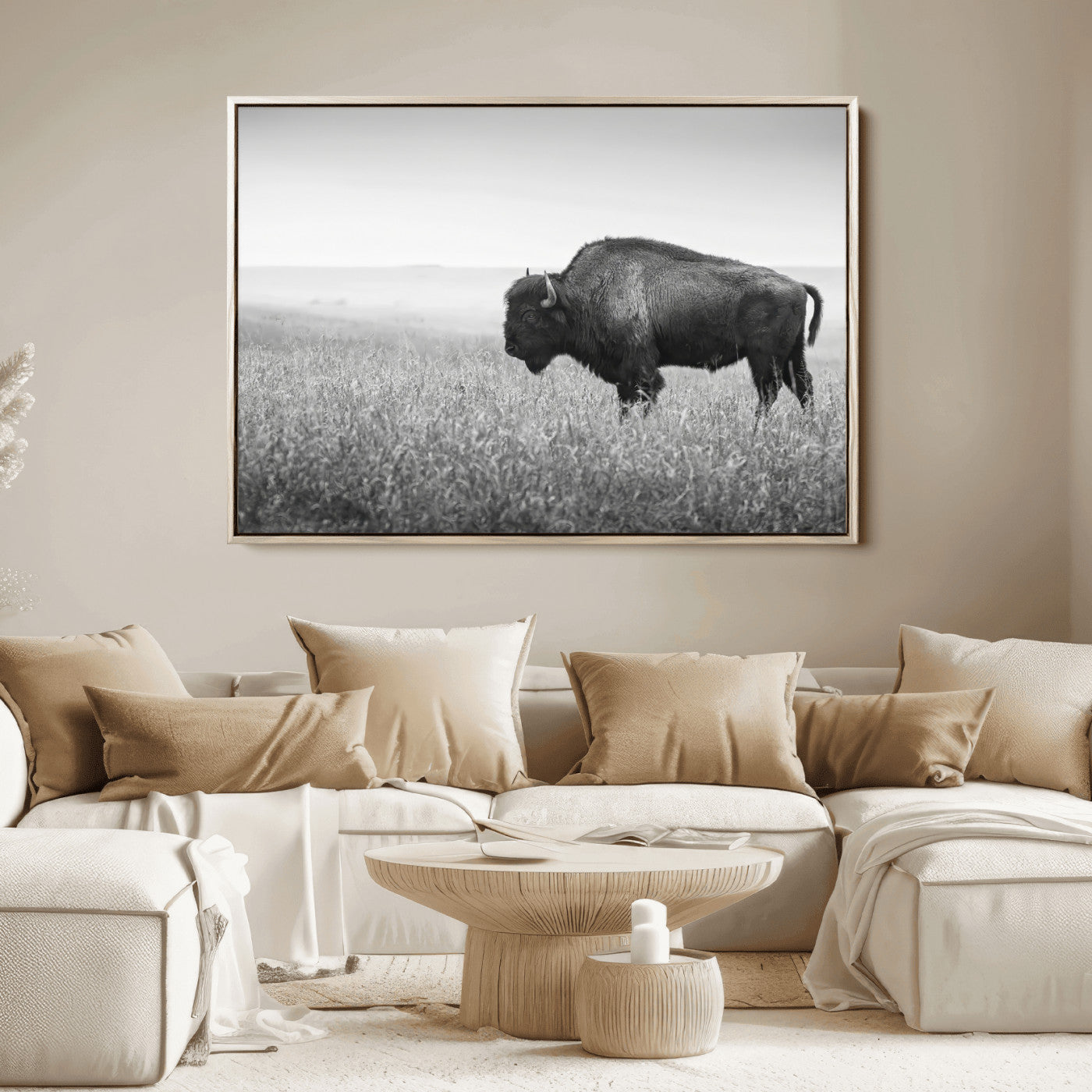 A black and white photograph of a majestic bison standing in a vast grassy prairie, evoking a sense of wilderness and strength.