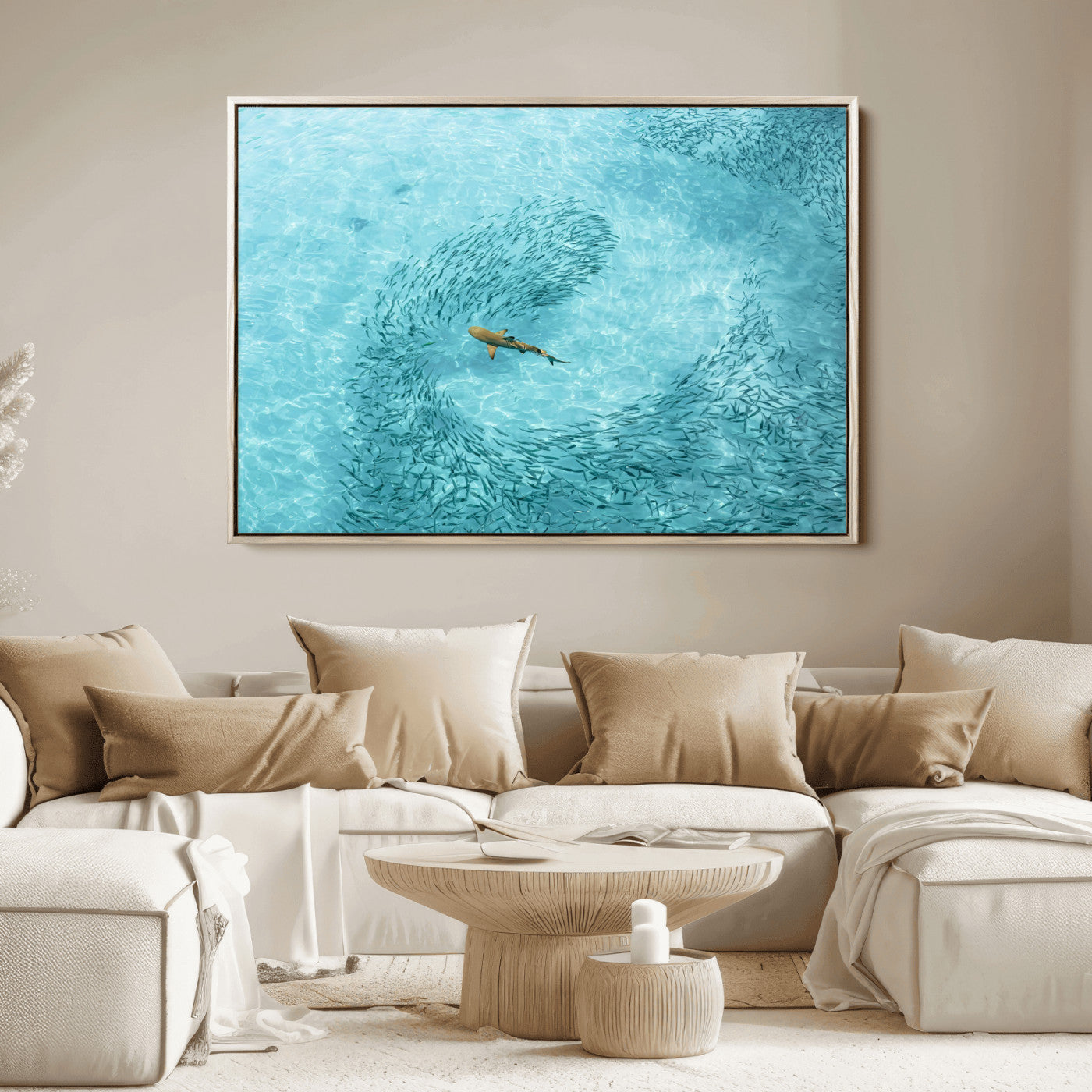Aerial view of a shark swimming through a swirl of fish in clear turquoise waters, perfect for calm coastal or beach house decor.