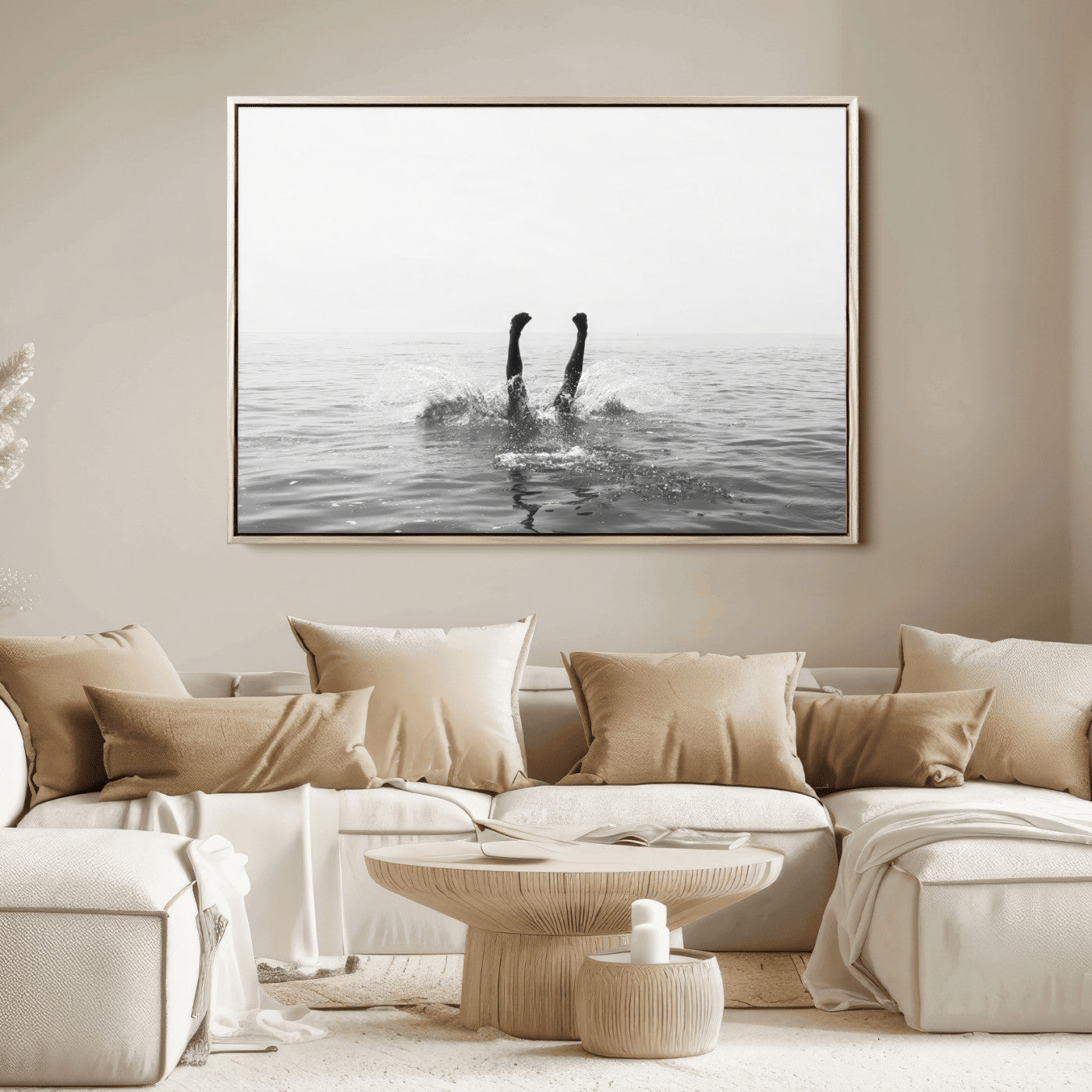 A black and white minimalist water scene capturing a playful splash as a swimmer dives upside down, creating a carefree and artistic aquatic aesthetic.